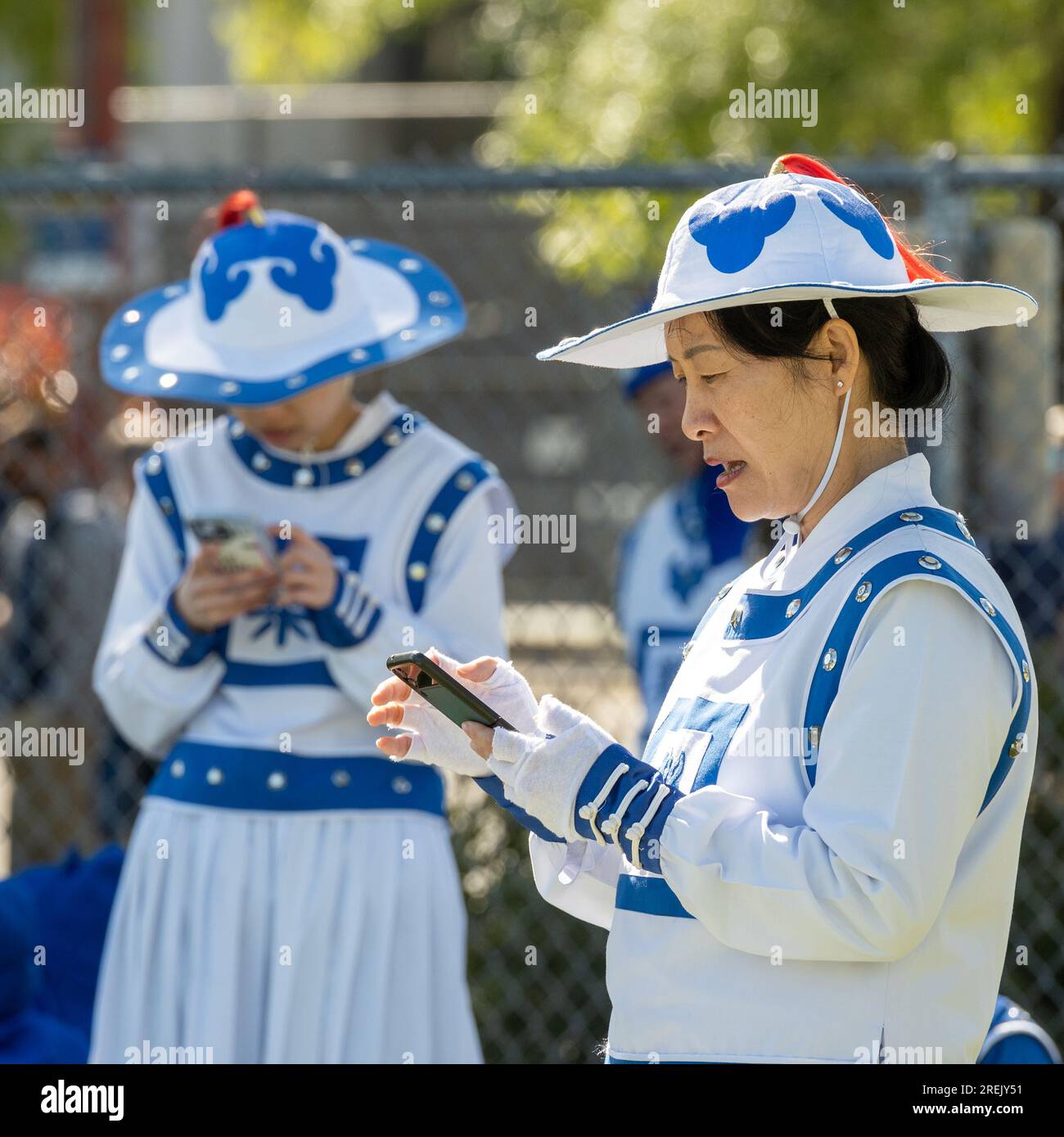Davis, CA - 15 aprile 2023. Picnic Day Parade presso l'Università della California a Davis con membri della band Falun Dafa in uniforme blu Foto Stock