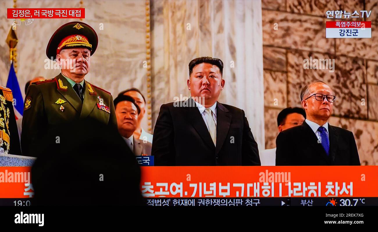 Uno schermo televisivo mostra un'immagine del leader nordcoreano Kim Jong un (C) con il ministro della difesa russo Sergei Shoigu (L) e il membro del politburo del Partito Comunista Cinese li Hongzhong (R) durante una parata militare in occasione del 70° anniversario della firma dell'armistizio che ha fermato la Corea del 1950-53 Guerra, durante un programma di notizie alla stazione ferroviaria di Yongsanl a Seoul. La Corea del Nord ha organizzato una massiccia parata militare per celebrare il 70 ° anniversario dell'armistizio della guerra di Corea, il 28 luglio i suoi media statali hanno mostrato i suoi ultimi missili balistici intercontinentali (ICBM) e droni in una mostra dei suoi militari Foto Stock