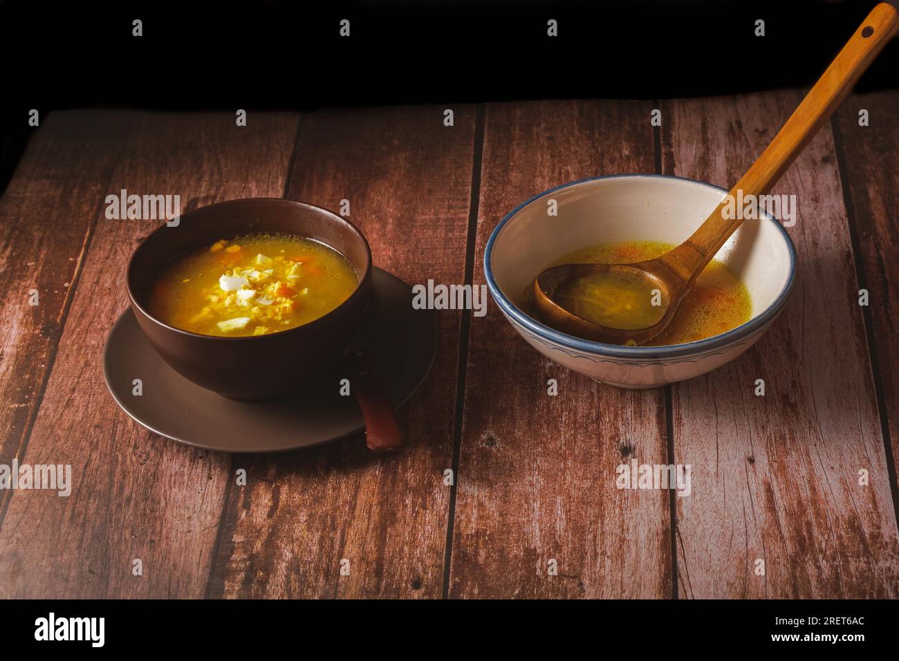 Ciotola con zuppa di spaghetti di pollo e zuppa tureen con cucchiaio di legno Foto Stock