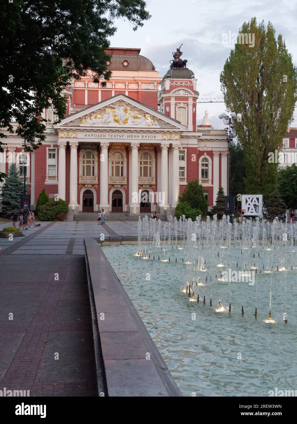 Ivan Vazov National Theatre, situato nell'area dei giardini della città, con fontana e visitatori, Sofia, Bulgaria. 29 luglio 2023 Foto Stock
