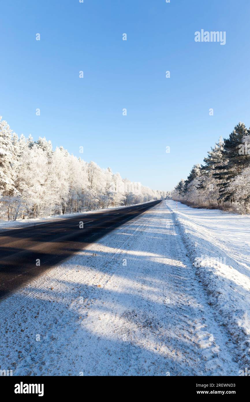 strada nella stagione invernale, neve che cadde durante la nevicata sulla strada, nevicate nella stagione invernale e strade asfaltate Foto Stock