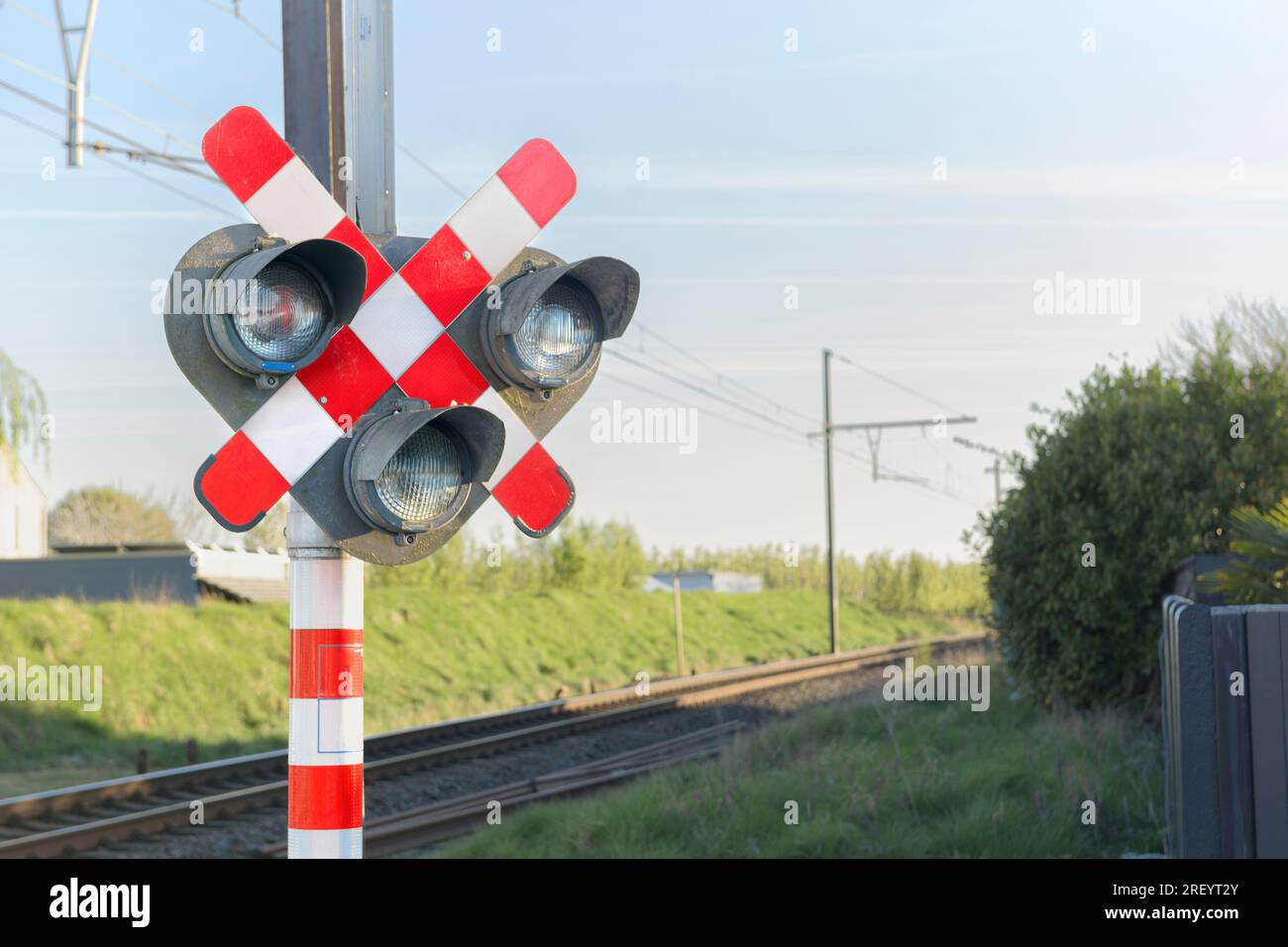 Segnalatore ferroviario - semaforo e barriera. Attraversamento ferroviario. Cartello segnaletico della prossimità di un attraversamento ferroviario. Foto Stock