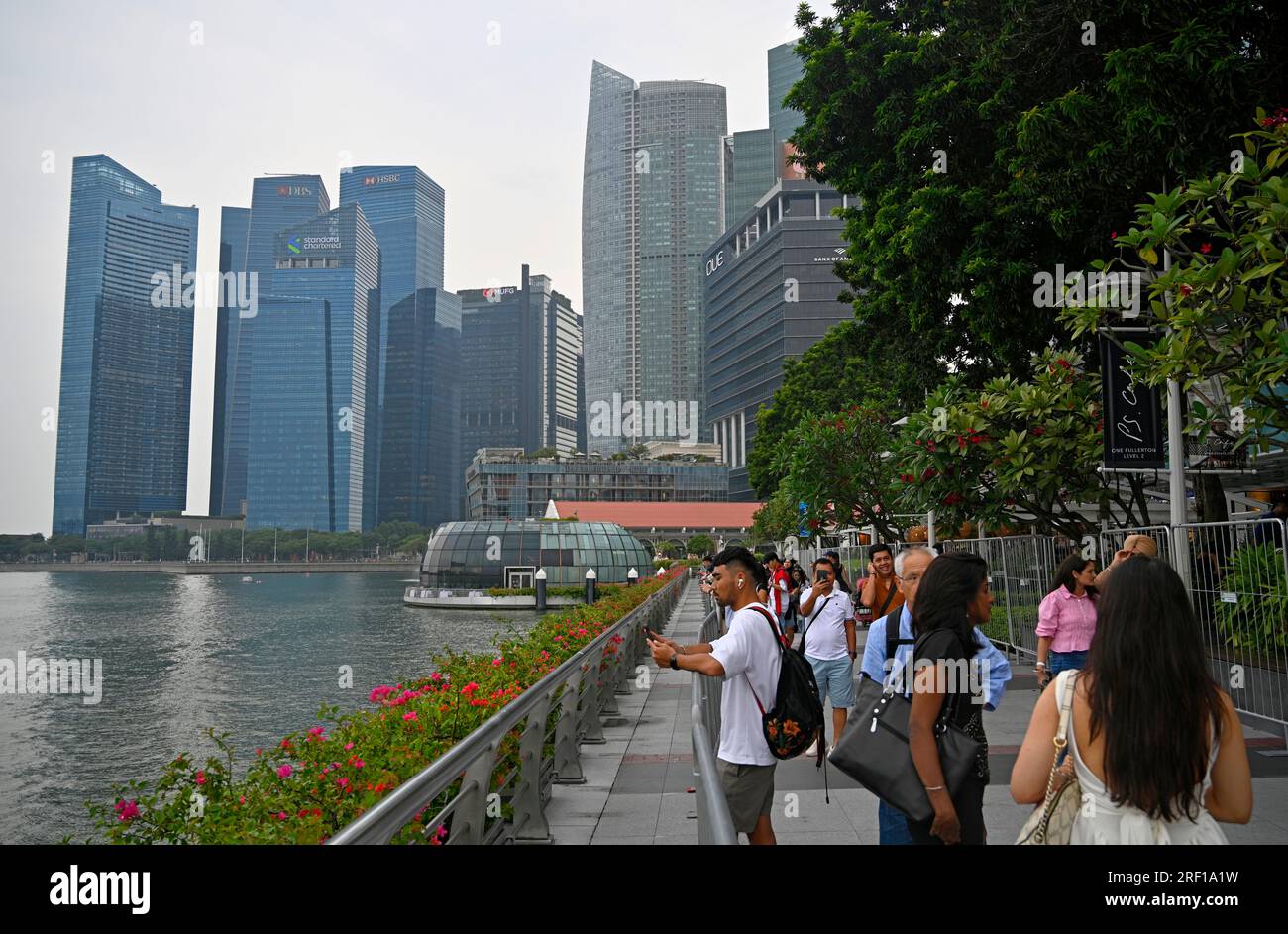 Singapore - 28 luglio 2023; i visitatori camminano lungo il viale a Marina Bay, nell'area dei ristoranti di Fullerton Road a Singapore Foto Stock