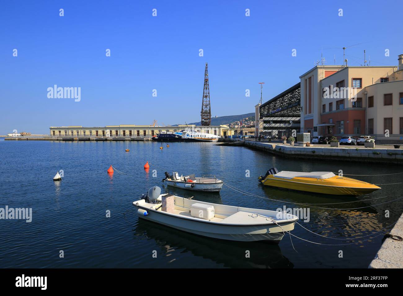Piccole barche a motore ormeggiate vicino alla riva di Trieste Foto Stock