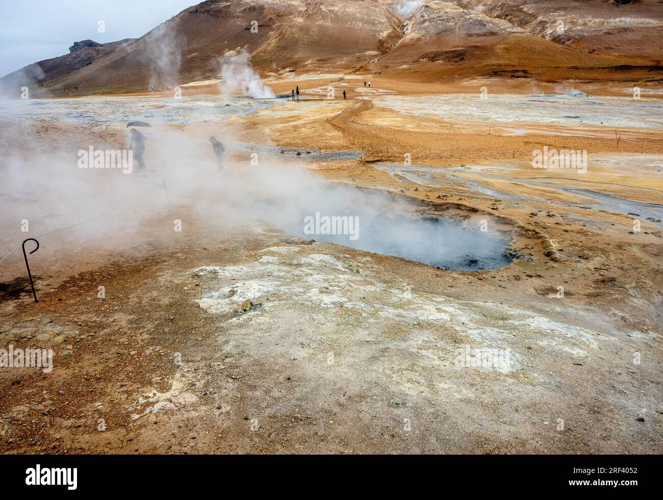 Piscine di fango bollenti e il monte Námafjall, area geotermica di Hverir, vicino al lago Mývatn, Islanda Foto Stock