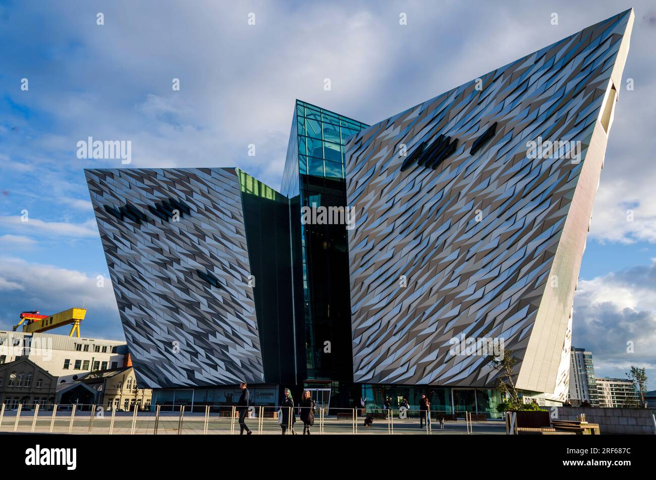 Titanic Quarter Belfast Irlanda del Nord, marzo 25 2023 - famoso Titanic Building con i turisti davanti e iconica gru sullo sfondo Foto Stock