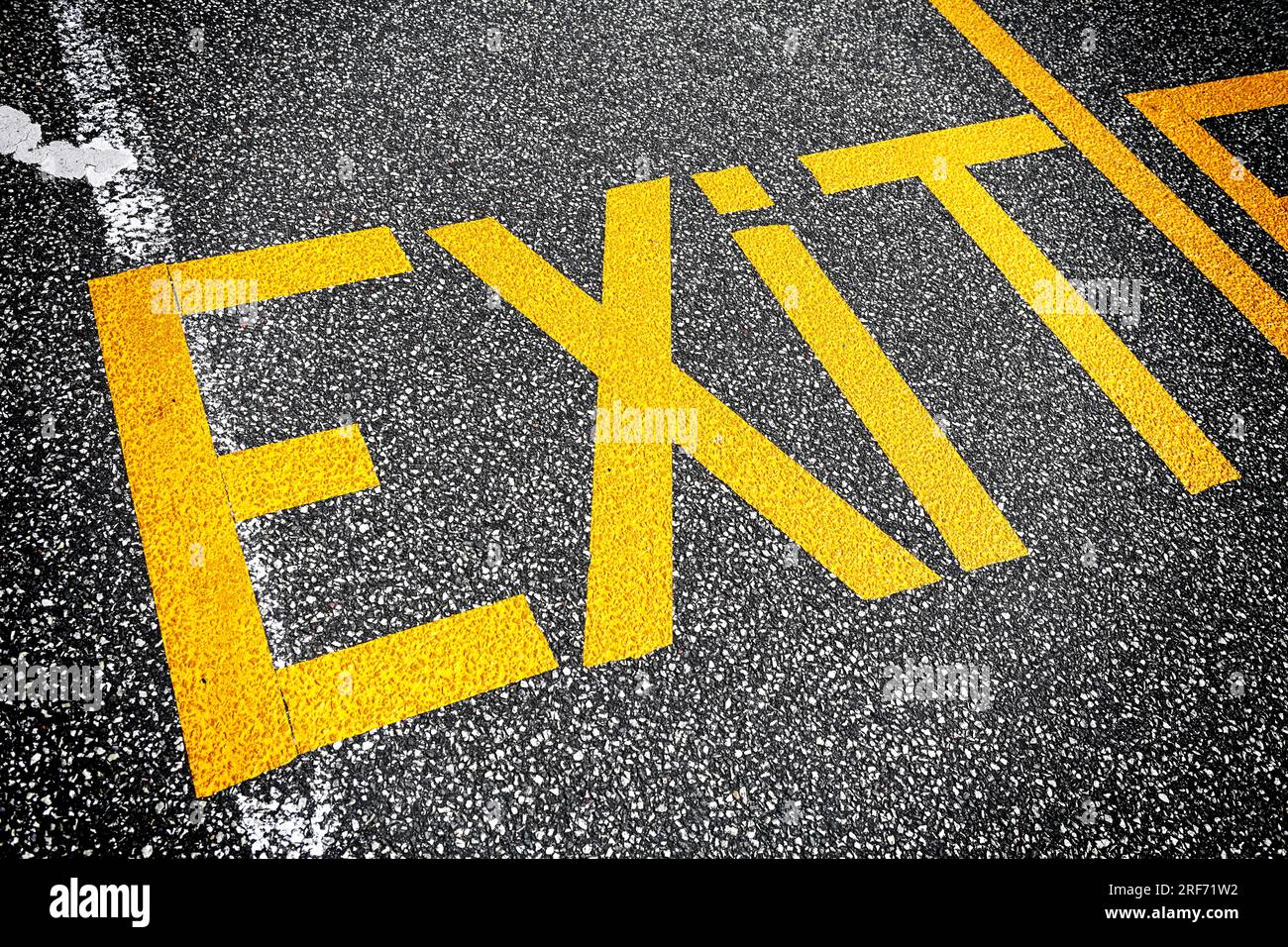 Das Wort Exit ist auf dem Ashalt geschrieben Foto Stock