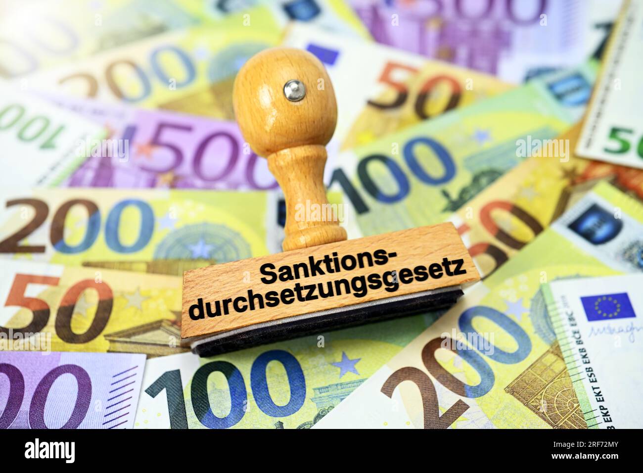 FOTOMONTAGE, Stempel mit Aufschrift Sanktionsdurchsetzungsgesetz auf Euroseinen Foto Stock