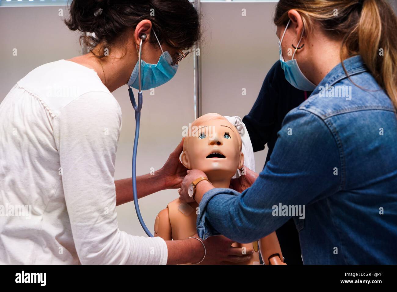 I medici generici sono addestrati alle procedure di emergenza pediatrica. Un medico svolge il ruolo della madre durante l'intervento. Foto Stock
