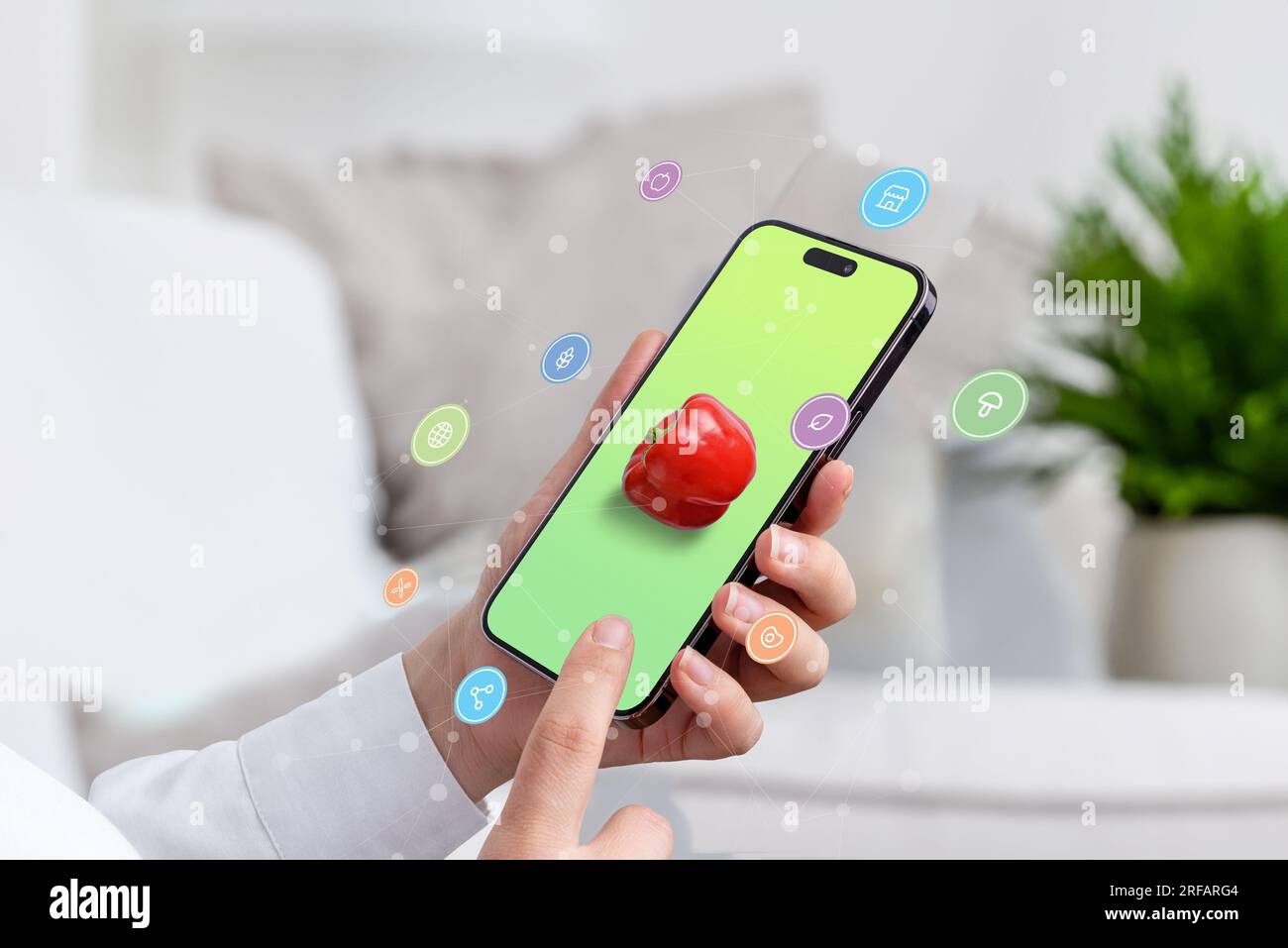 Uso di uno smartphone per cercare cibo sano online. concetto. Telefono in mano con pepe sullo schermo, shopping online e icone del cibo che volano con freccia Foto Stock