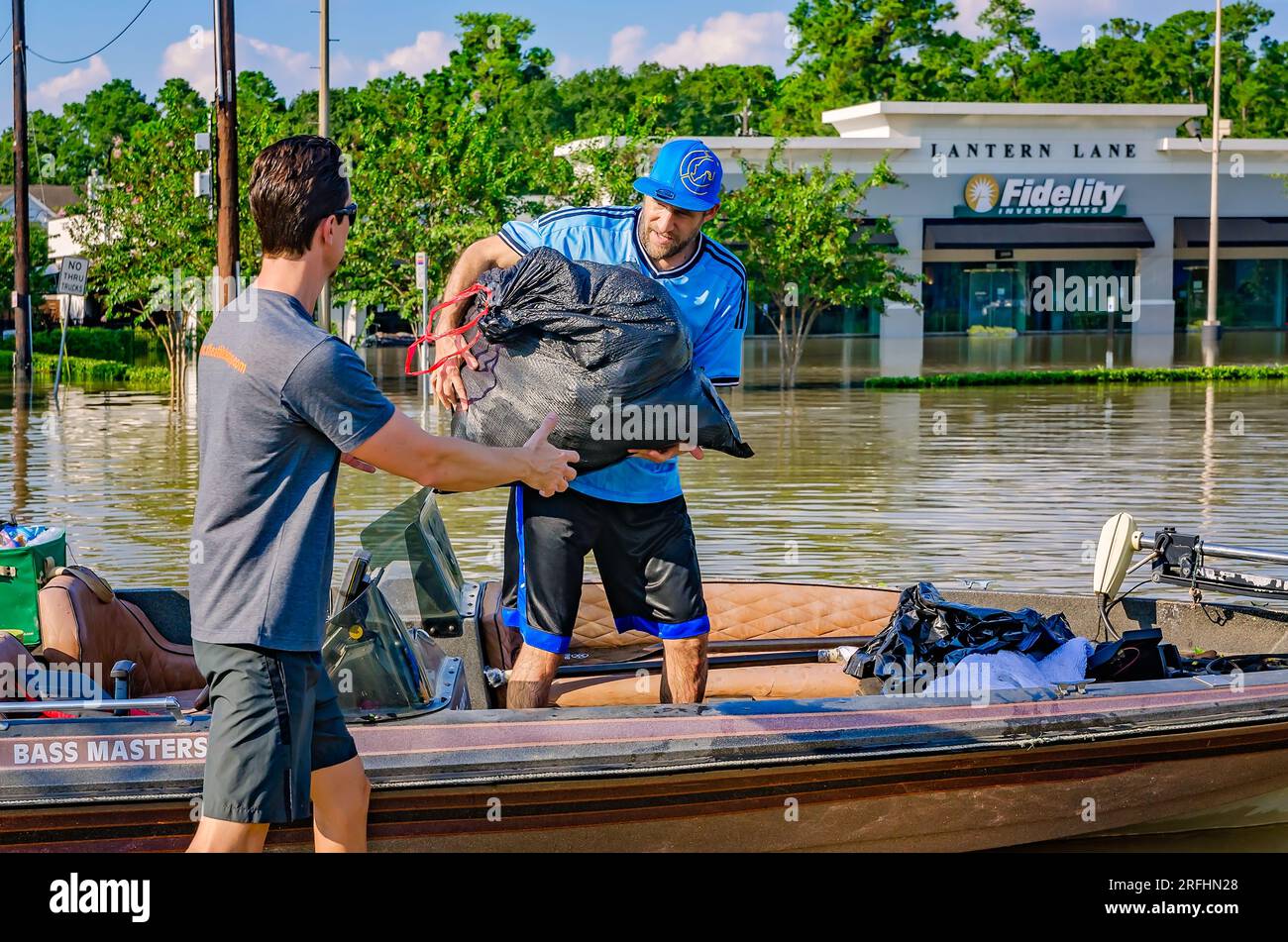 I volontari scaricano vestiti bagnati da una barca su una Memorial Drive allagata dopo l'uragano Harvey, 31 agosto 2017, a Houston, Texas. Foto Stock