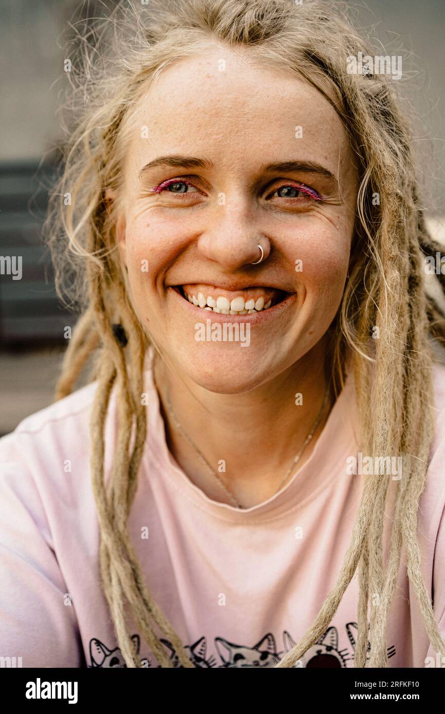 Giovane donna felice con dreadlocks sorridenti, ritratti, primi piani. Foto Stock