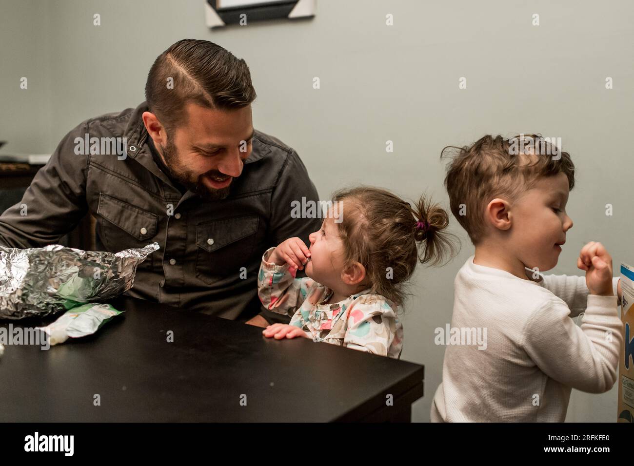 Papa' diverte i bambini all'ora di pranzo Foto Stock
