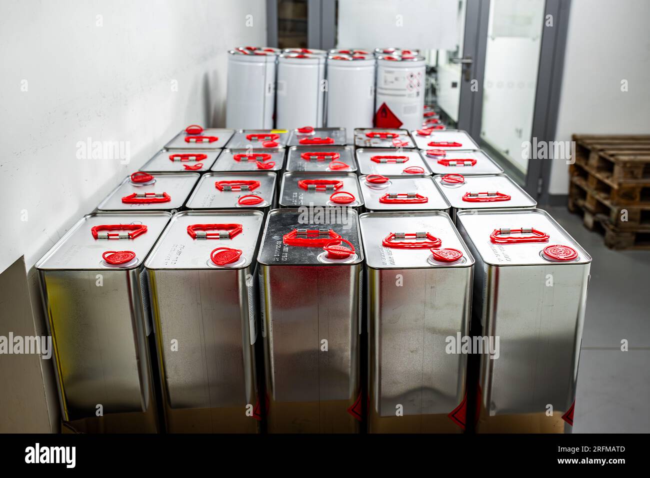 Liquido infiammabile in un contenitore metallico in un locale di stoccaggio, concetto di ricerca, manipolazione di sostanze pericolose Foto Stock