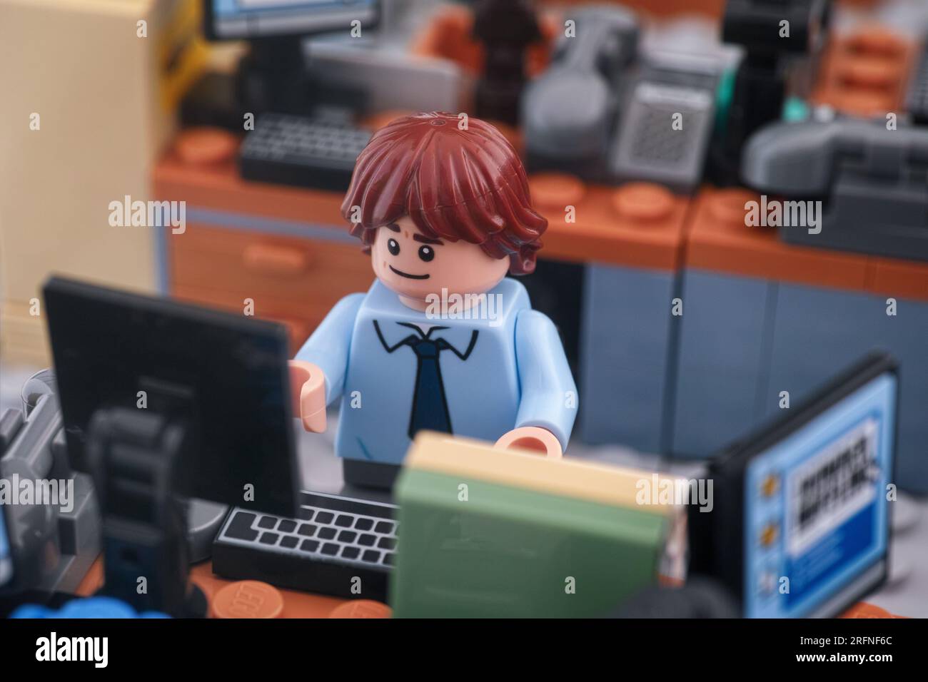Tambov, Federazione Russa - 4 agosto 2023 Una minifigura d'affari Lego che lavora su un computer in un ufficio. Primo piano. Foto Stock
