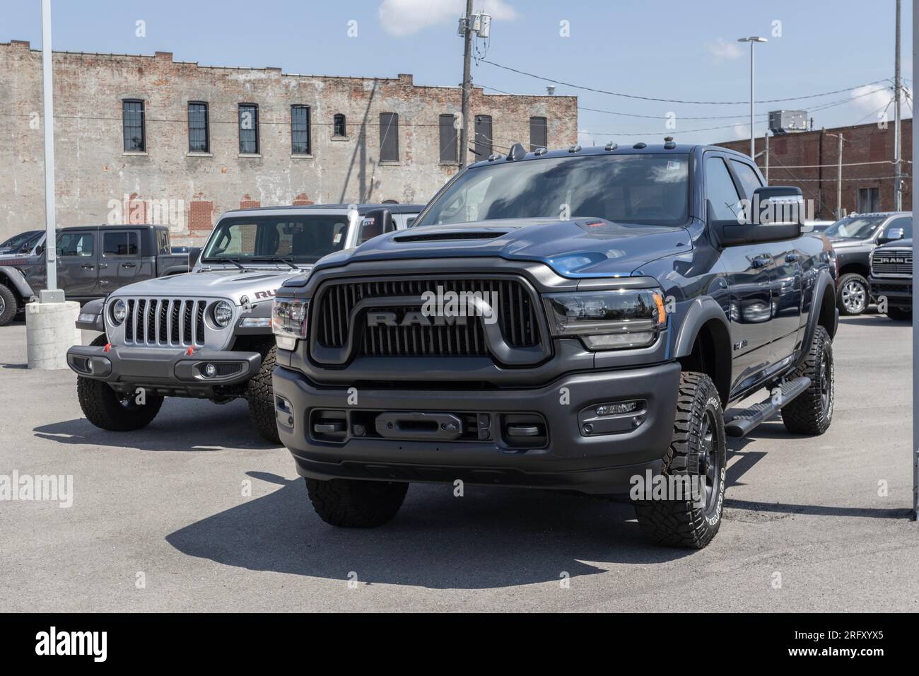 Logansport - 3 agosto 2023: RAM 2500 e Jeep Wrangler esposti presso una concessionaria, Jeep e RAM fanno parte della famiglia di auto e SUV Stellantis. Foto Stock