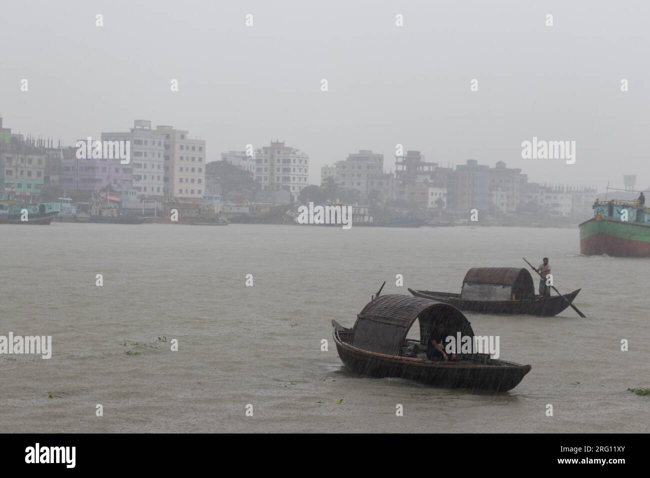 Narayanganj, Dacca, Bangladesh. 7 agosto 2023. I residenti attraversano il fiume Shitalakhya con barche di legno a Narayanganj, Bangladesh, in un giorno di pioggia. La stagione dei monsoni porta forti piogge nel paese. In effetti, circa il 80% delle piogge annuali del Bangladesh si verificano da giugno a ottobre e, alla fine della stagione dei monsoni, quasi un terzo del paese è sott'acqua. Il Bangladesh è un paese molto umido, che riceve in media circa 2.200 millimetri (mm) di precipitazioni all'anno. (Immagine di credito: © Joy Saha/ZUMA Press Wire) SOLO USO EDITORIALE! Non per USO commerciale! Foto Stock