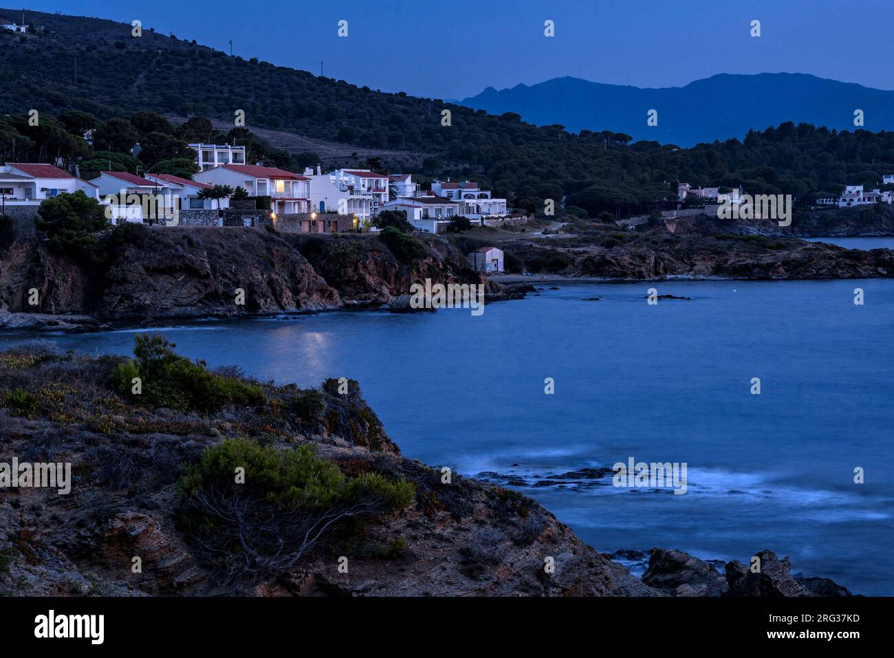 Case vicino alla costa della baia di Port de la Selva all'ora blu con la prima luce del mattino (Alt Empordà, Girona, Catalogna, Spagna) Foto Stock