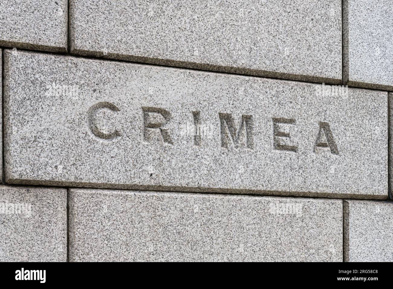 Word Crimea scolpita su mattoni nel muro Foto Stock
