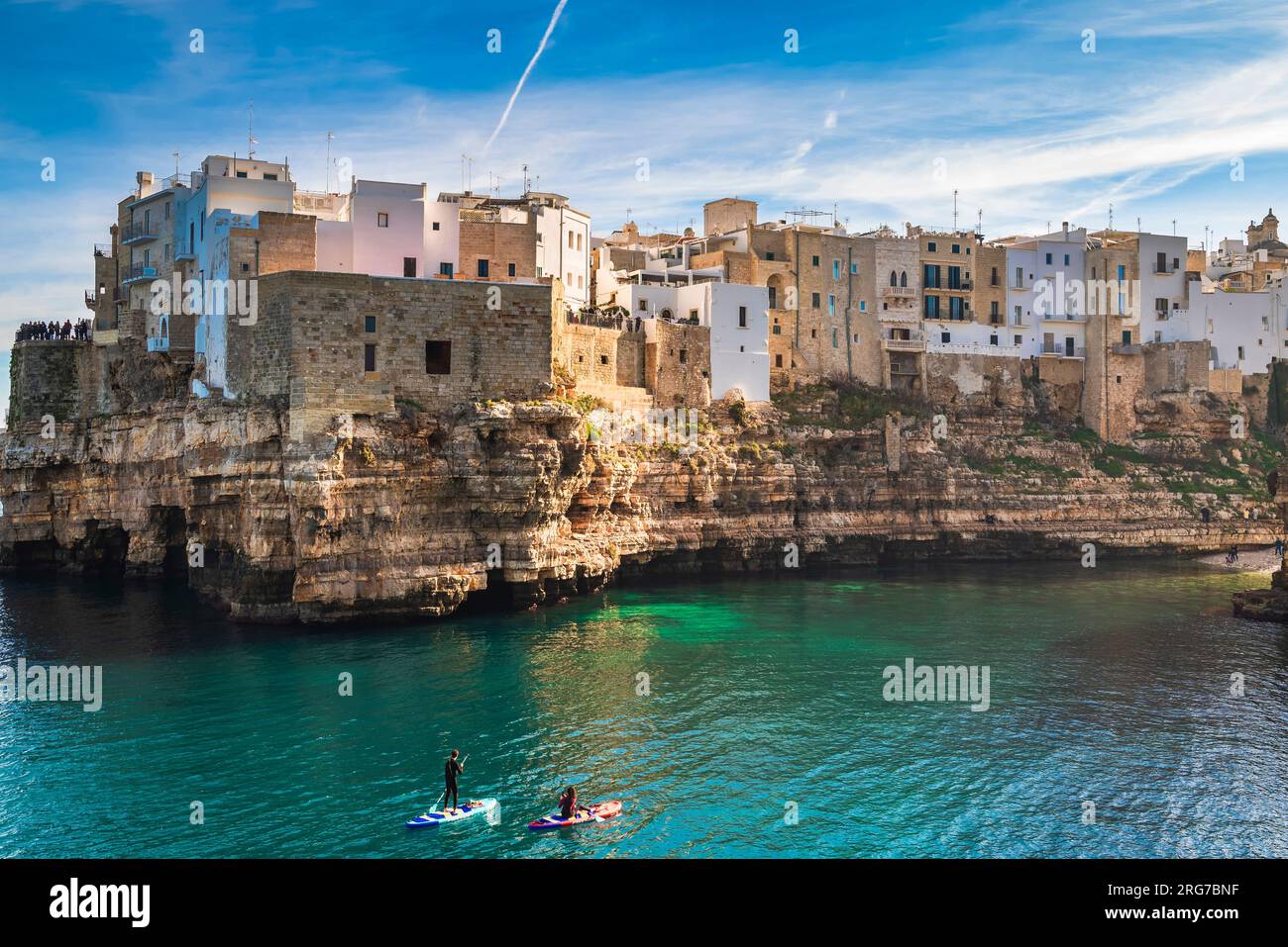 Polignano a Mare, Italia - 2 gennaio 2023: Le acque turchesi calme e limpide della baia di Lama Monachile ideali per gli sport acquatici Foto Stock