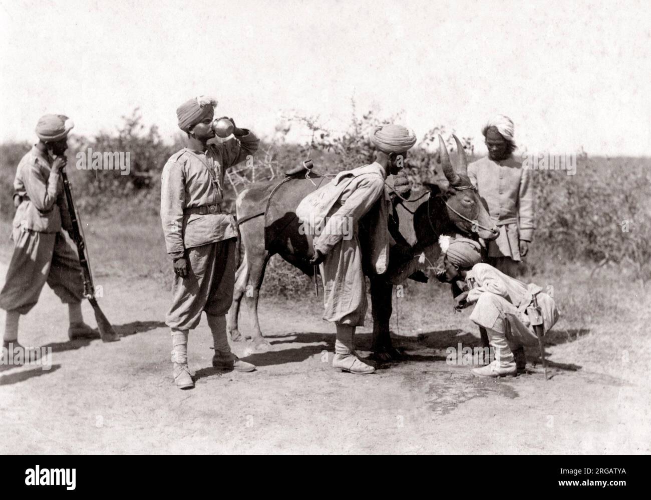 C. 1880 India - i soldati di ottenere acqua da un bheestie water carrier Foto Stock