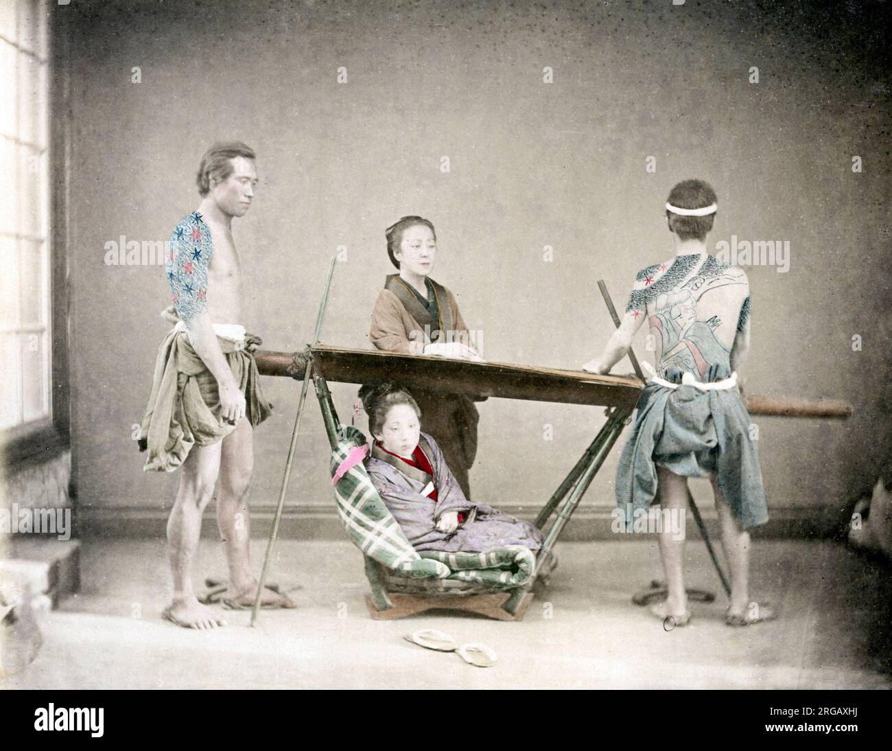 C. 1880 Giappone - donna in portantina con tatuato portatori Foto Stock