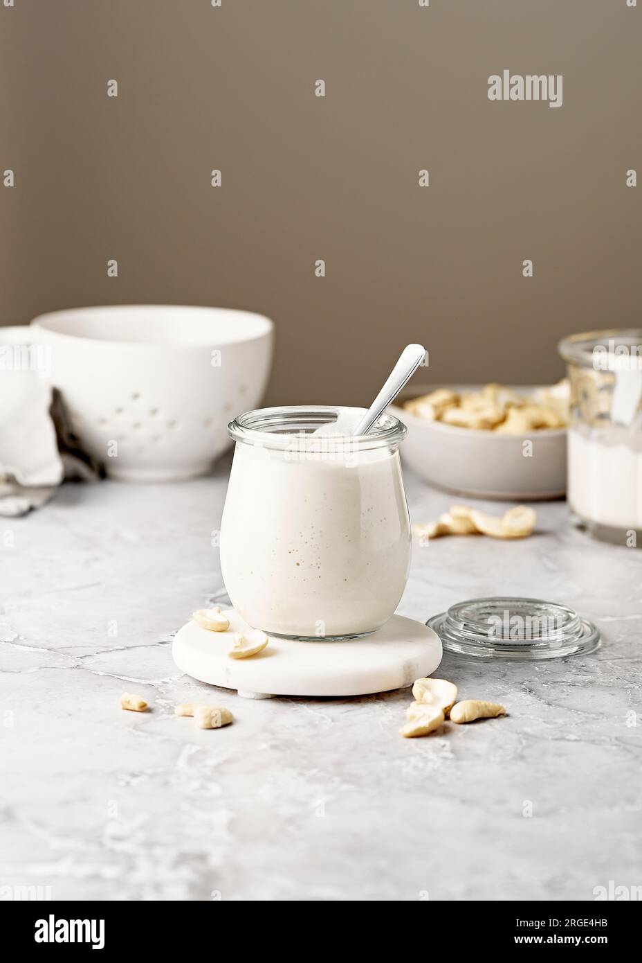 Crema di anacardi con cucchiaio su superficie di marmo Foto Stock