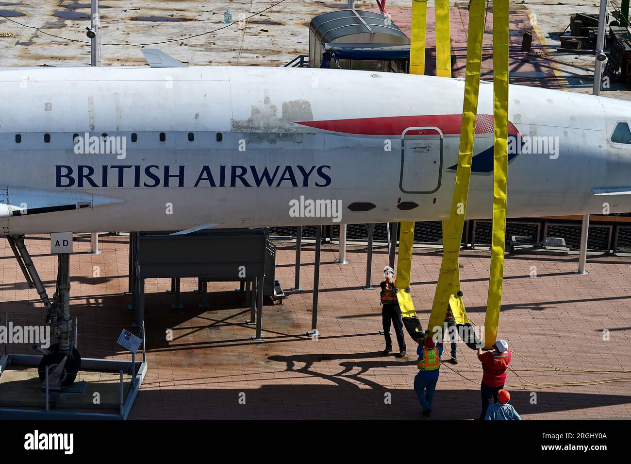 New York, USA. 9 agosto 2023. I lavoratori si preparano a spostare il British Airways Concorde posizionando le imbracature sotto la fusoliera anteriore, dove verrà issato da una gru su una chiatta in attesa, presso l'Intrepid Sea, Air and Space Museum, New York, NY, 9 agosto 2023. Il British Airways Concorde, un aereo di linea supersonico franco-britannico in pensione che era l'aereo commerciale più veloce al mondo (Mach 2), fu trasferito ai Brooklyn Navy Yards dove è previsto un restauro di tre mesi. (Foto di Anthony Behar/Sipa USA) credito: SIPA USA/Alamy Live News Foto Stock