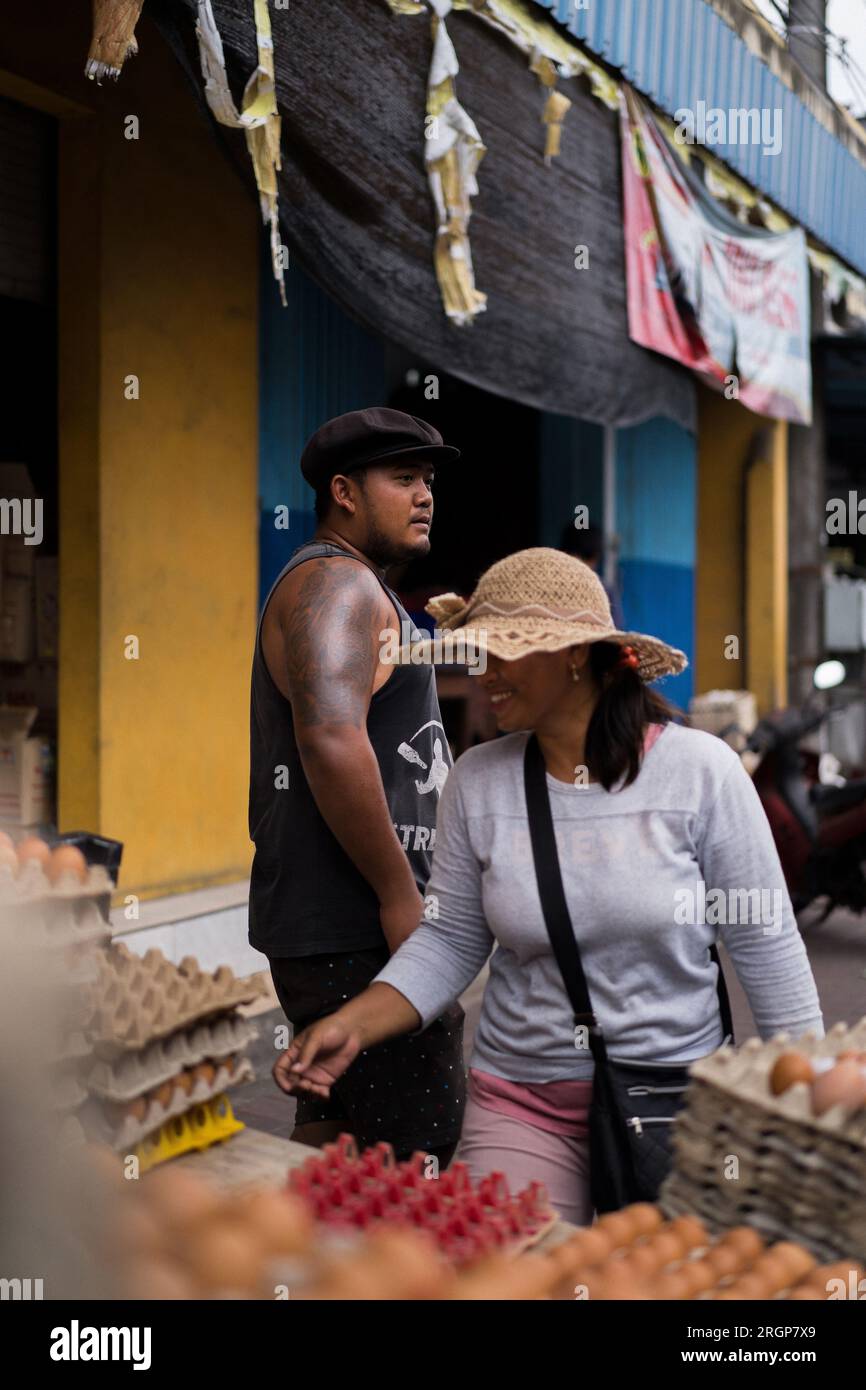 Un giovane indonesiano e una balinese vendono uova di gallina. Foto Stock
