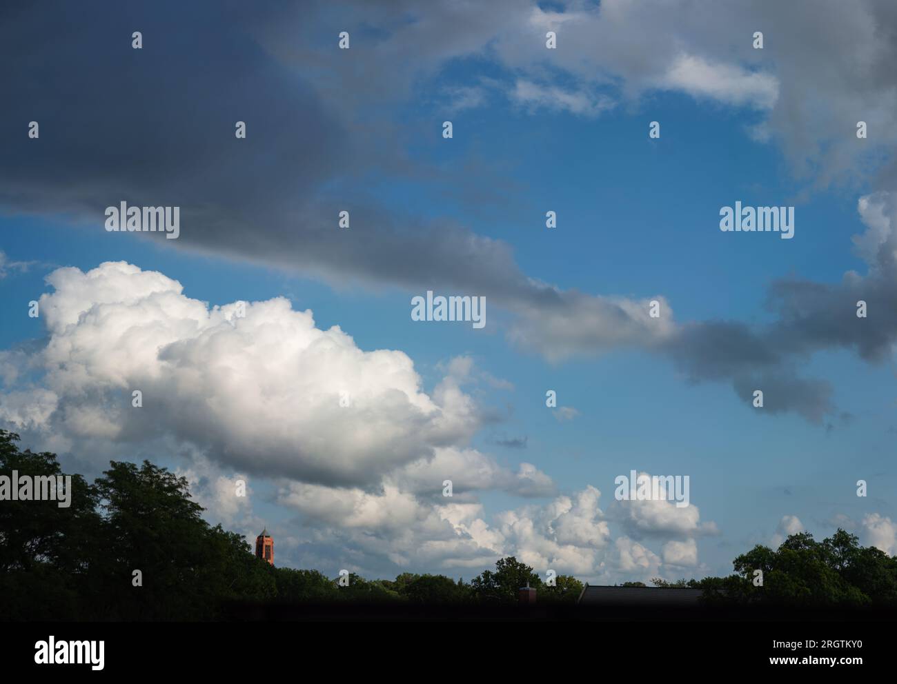 Condizioni climatiche favorevoli, le nuvole di cumulus si librano su Lincoln in una sera d'estate. Lincoln, Nebraska, USA. Foto Stock