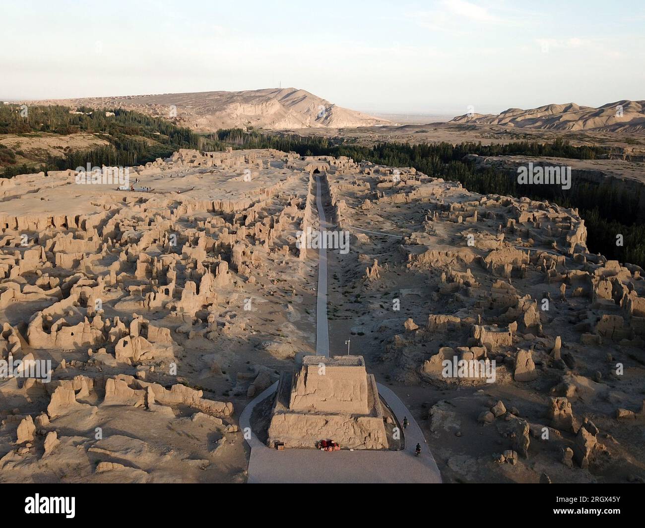 Turpan. 11 agosto 2023. Questa foto aerea scattata l'11 agosto 2023 mostra l'antica città di Jiaohe al tramonto a Turpan, nella regione autonoma uigura dello Xinjiang della Cina nordoccidentale. L'antica città di Jiaohe, situata nell'oasi a nord del bacino della Turfan, era una volta un'importante città sull'antica via della seta, ed è stata elencata come una delle prime unità di protezione delle reliquie culturali chiave a livello nazionale nel 1961. Crediti: Ma Ning/Xinhua/Alamy Live News Foto Stock