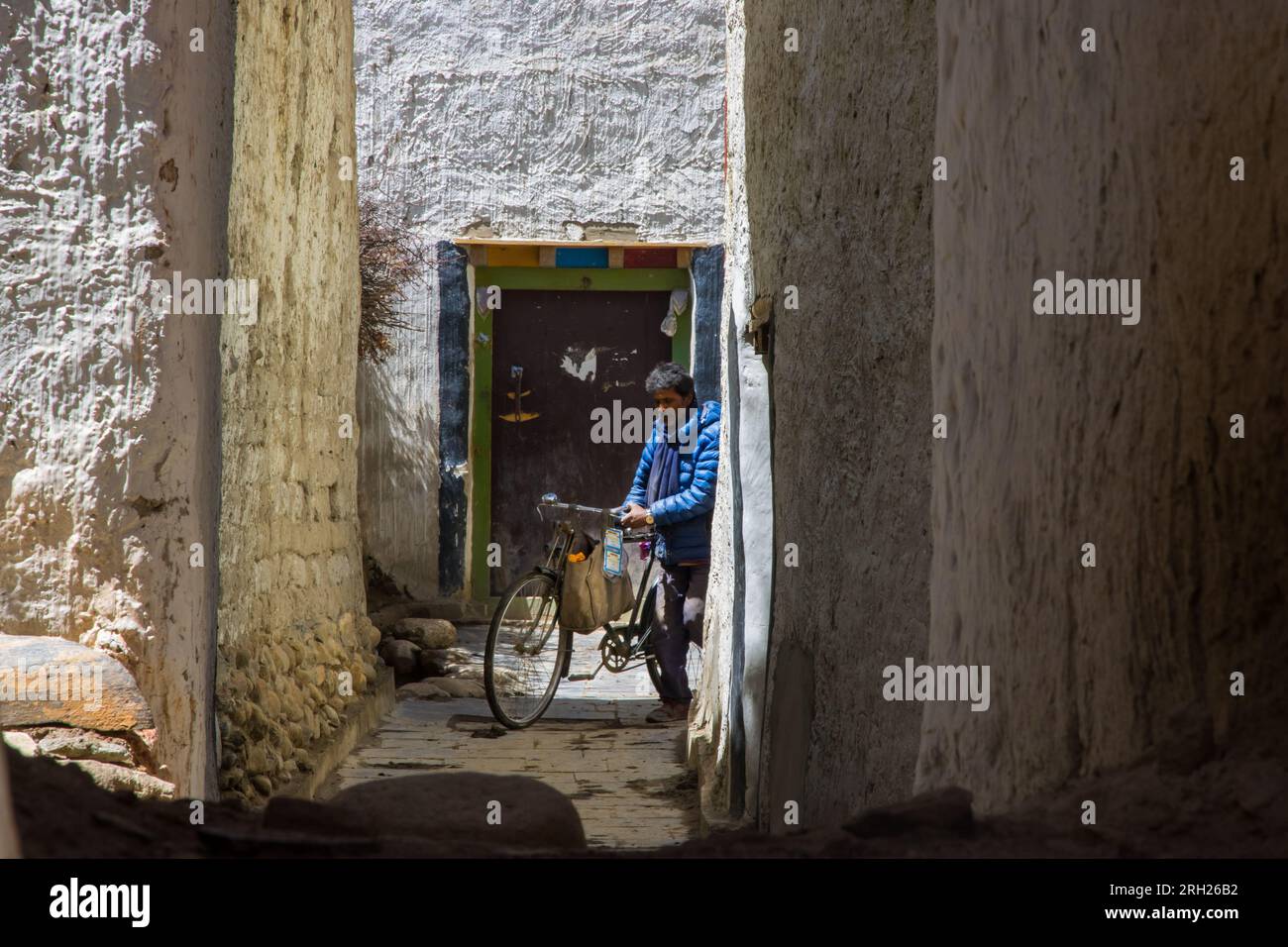 Lo Manthang, Nepal - 23 luglio 2023: Un lavoratore con la sua bicicletta per le strade di lo Manthang nell'Upper Mustang del Nepal Foto Stock