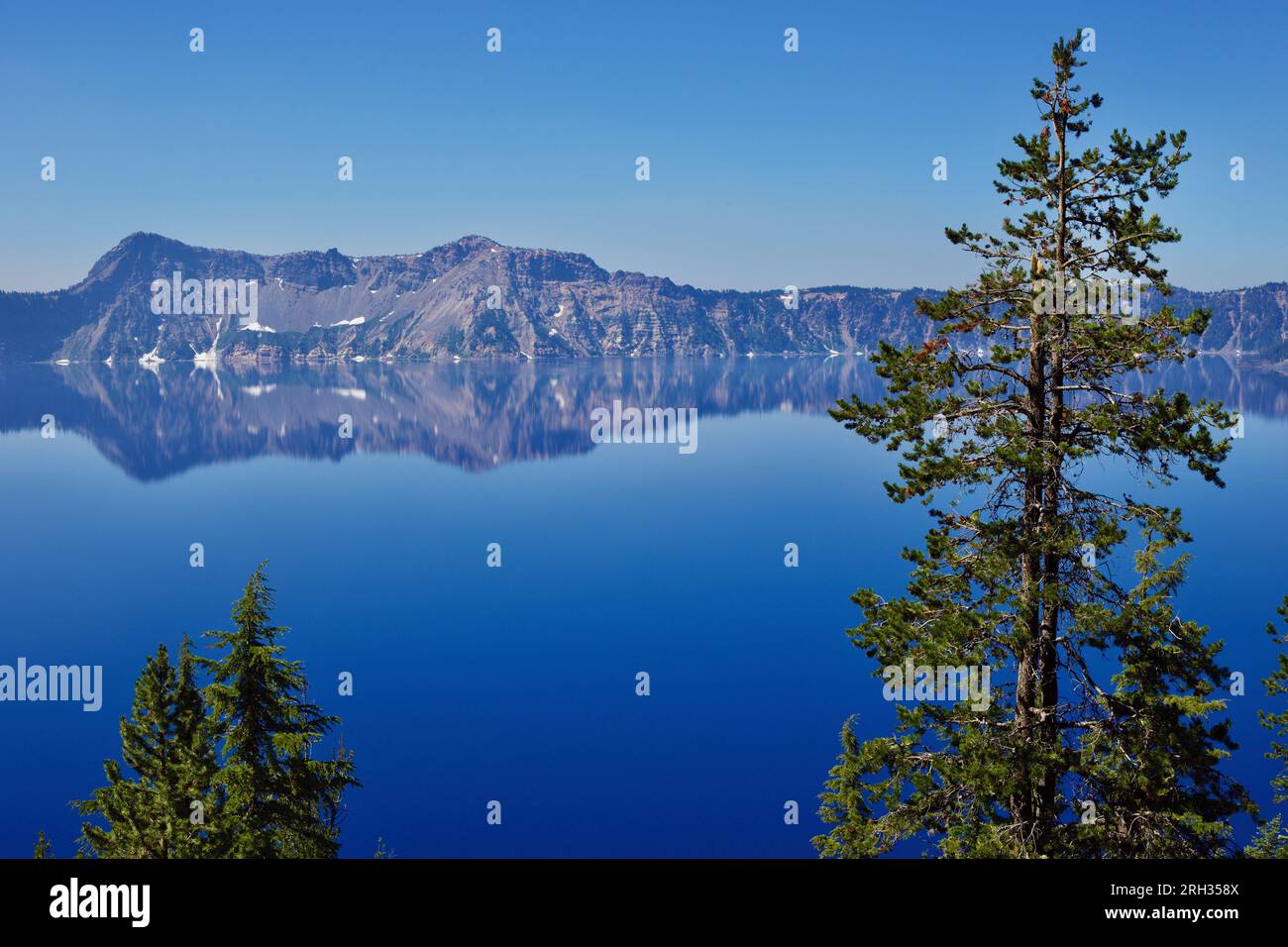 Una fotografia del Crater Lake in Oregon, USA, con riflessi e alberi. Foto Stock