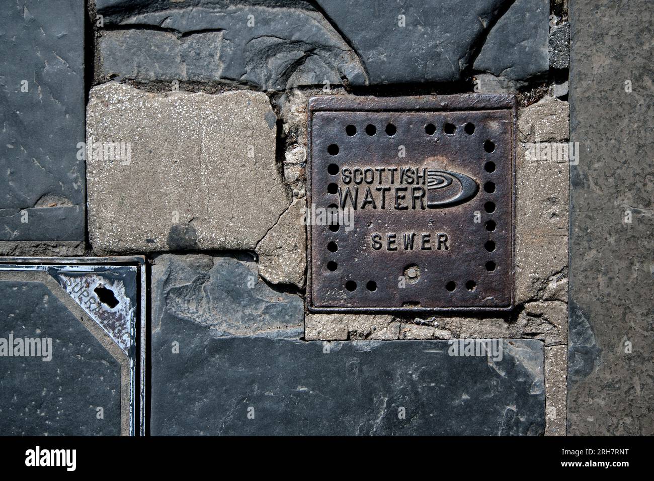 Scottish Water Sewer Cover in una strada a Edimburgo, Scozia, Regno Unito Foto Stock
