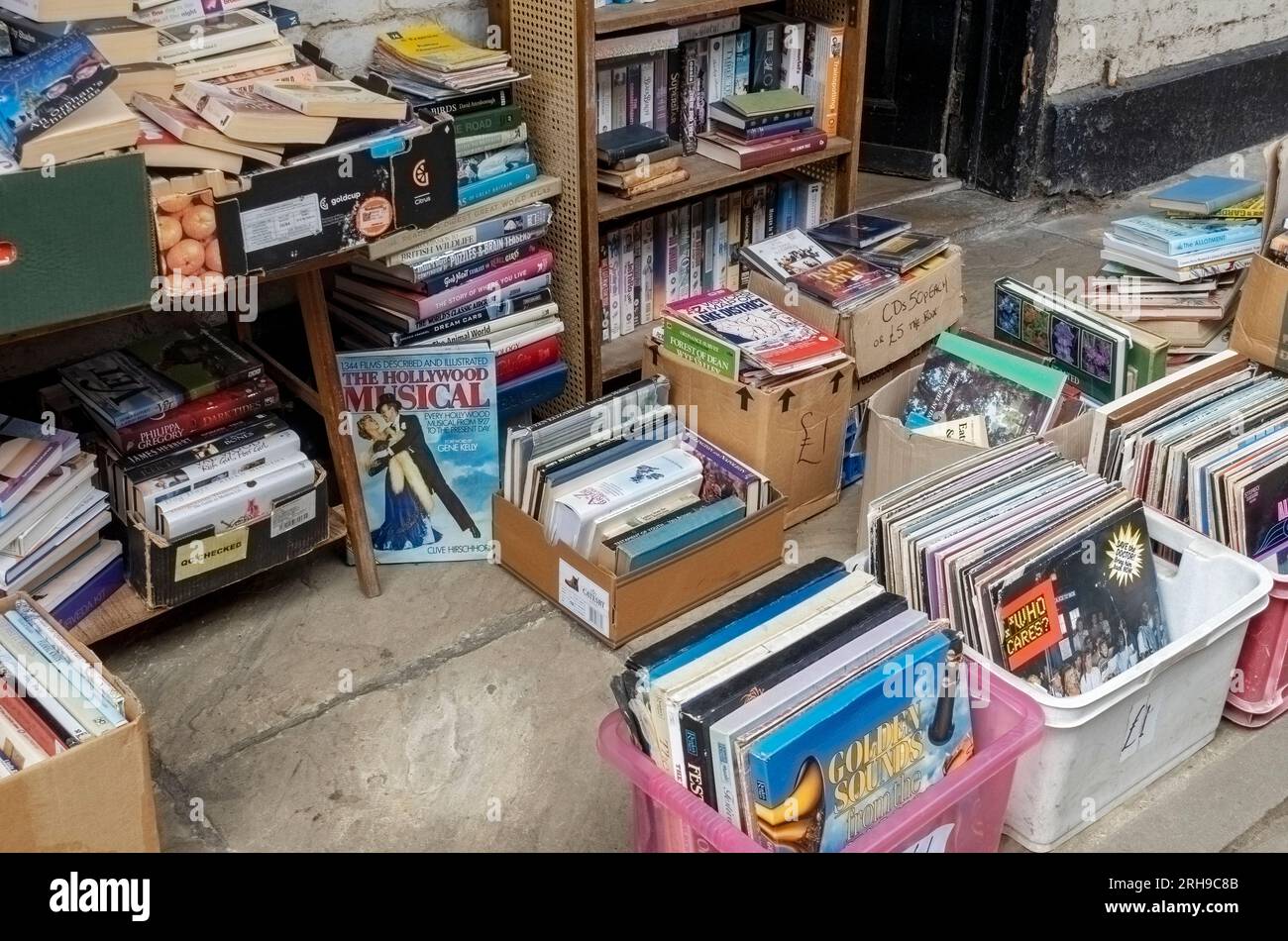 Scatole di libri e registri di seconda mano in vendita all'esterno del negozio commerciale locale indipendente Market Street Malton North Yorkshire Inghilterra Regno Unito Gran Bretagna Foto Stock
