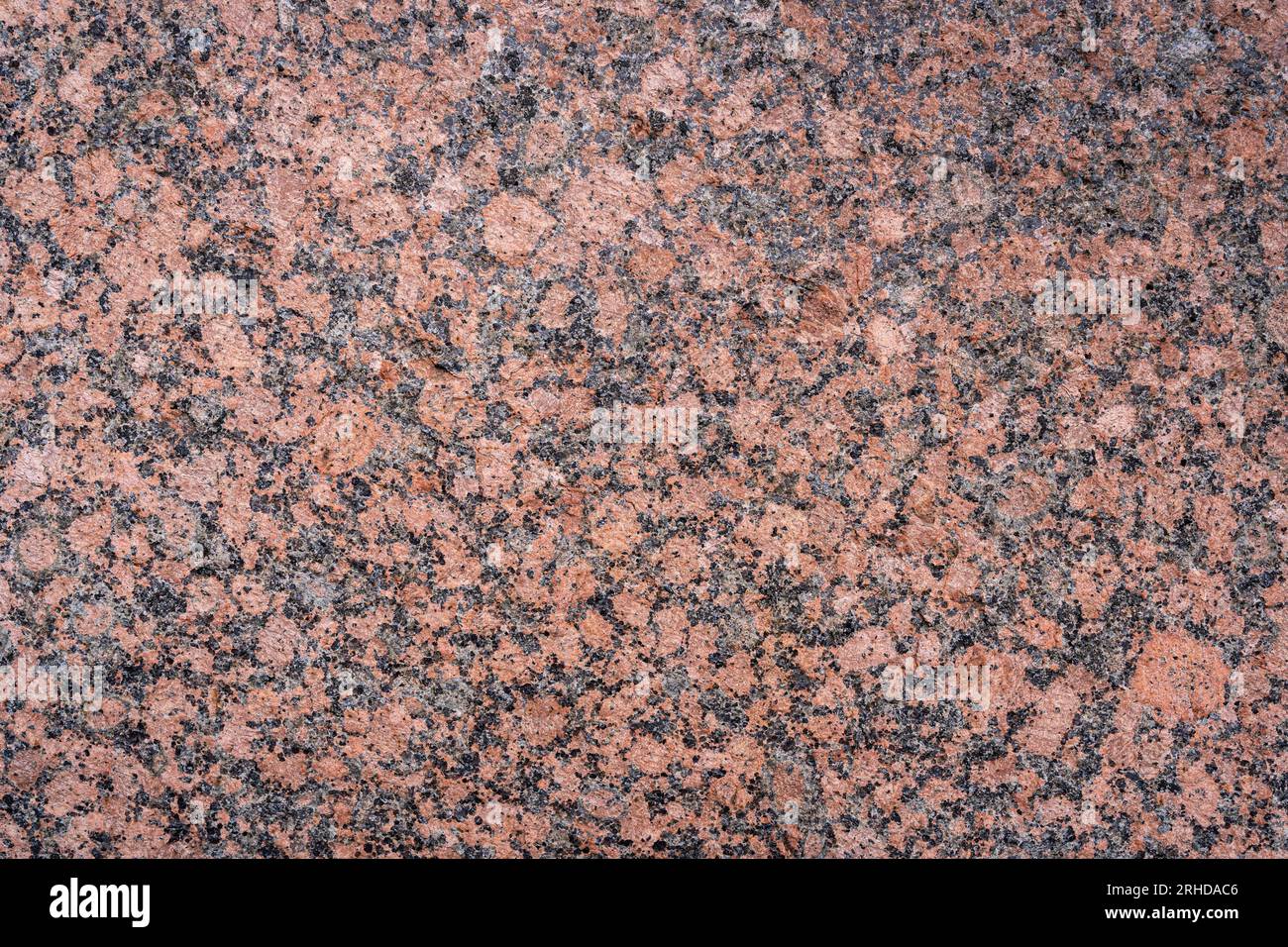 Vista ravvicinata della lastra di granito rosa lucido testurizzato Foto Stock