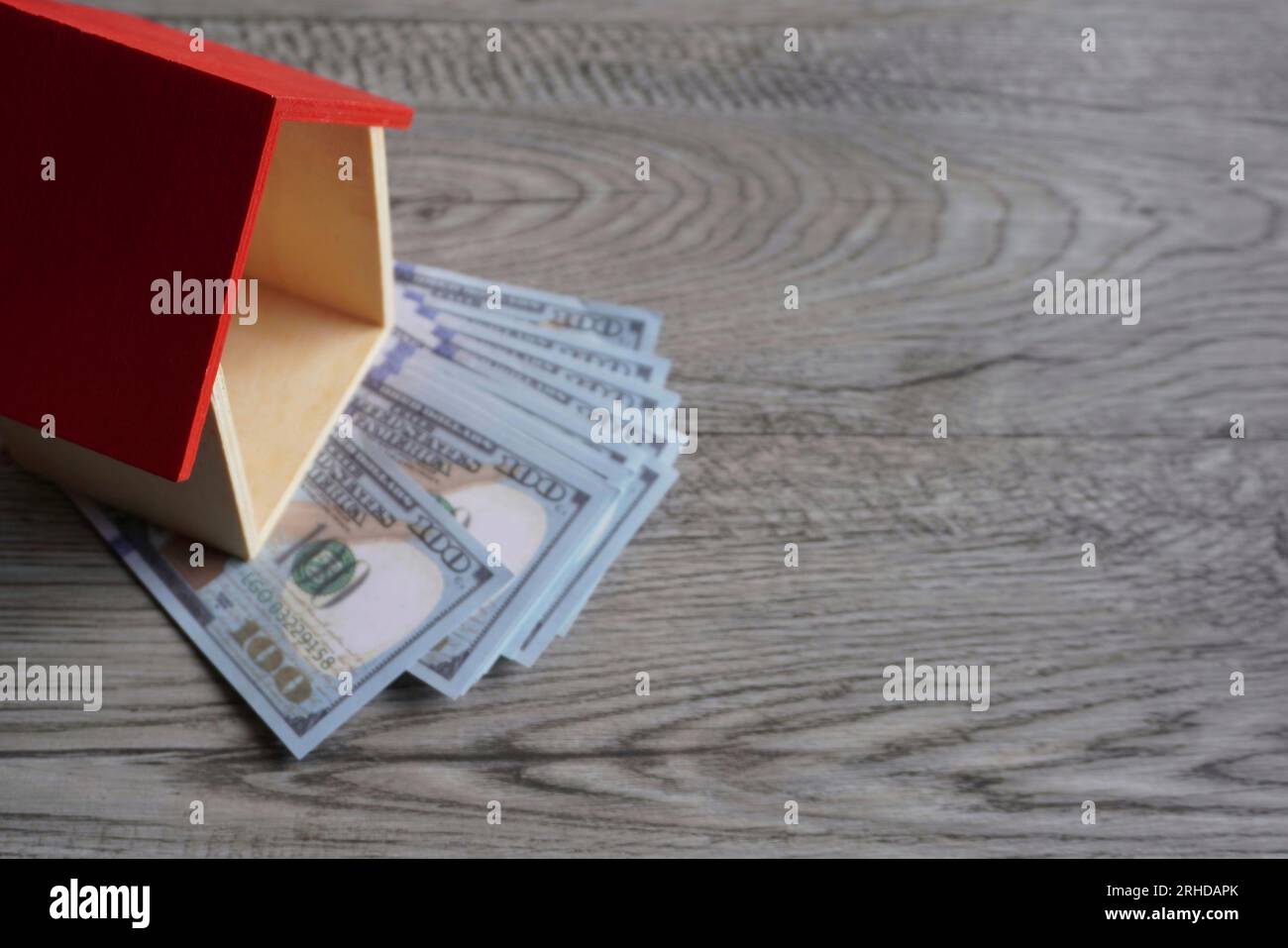 Immagine ravvicinata della casa dei giocattoli e del denaro. Spazio di copia per il testo. Concetto immobiliare e immobiliare. Foto Stock