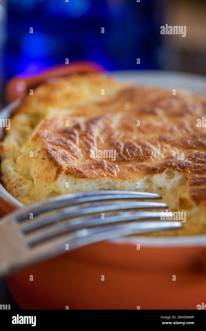 Souffle francese di uova in Red Pot con forchetta nel ristorante Foto Stock