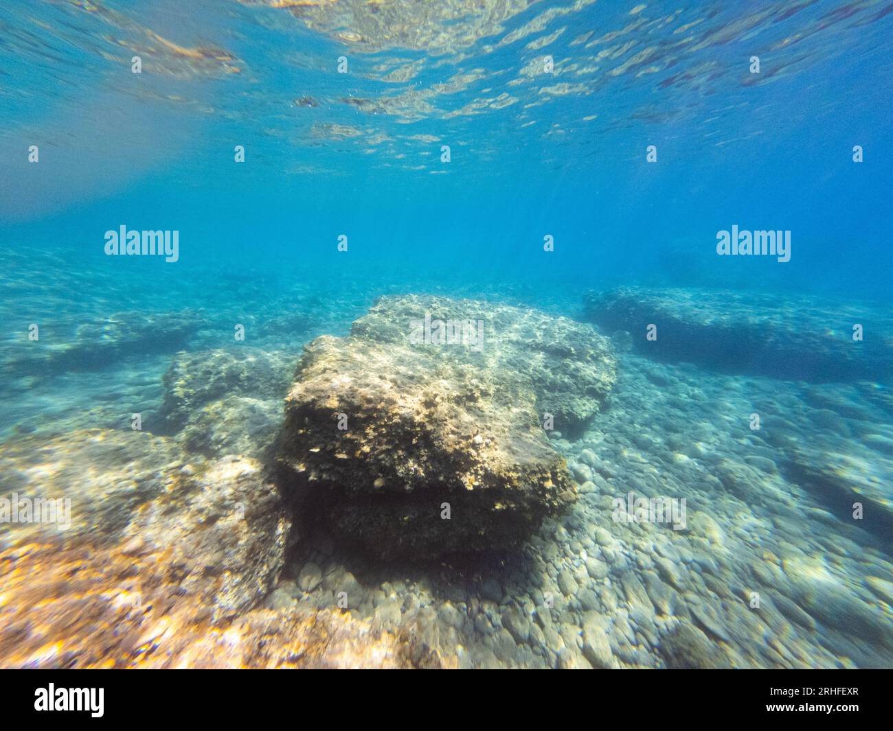 Vista sottomarina del Mar Egeo. Grandi frammenti di roccia nel mare limpido. Grandangolo Foto Stock