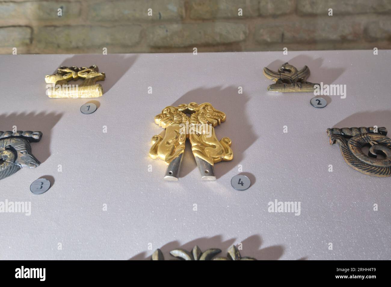 Un piccolo artefatto d'oro di un drago a doppia testa, animale. In stile Timirud, luogo simbolo dell'era della via della seta, il mausoleo Khoja Ahmed Yasawi a Turkesta Foto Stock