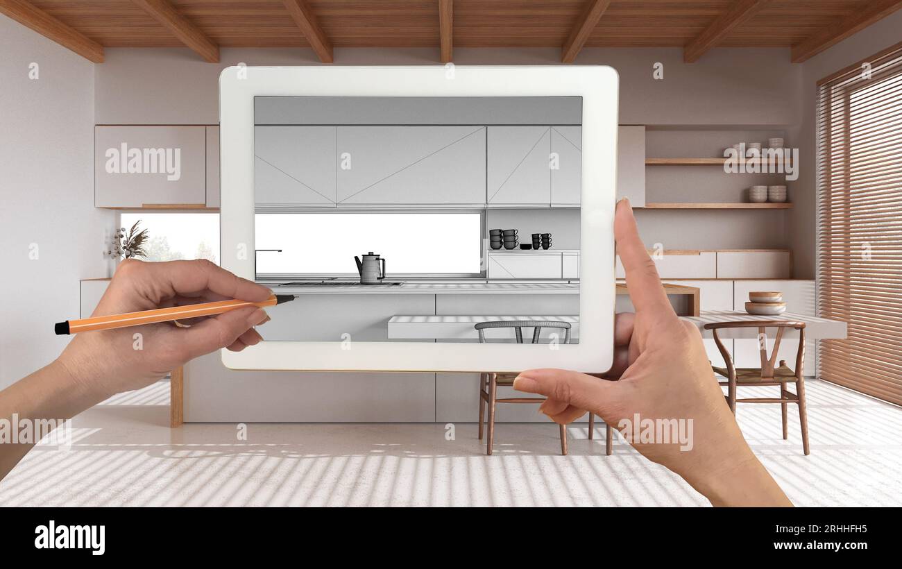Mani che tengono e disegnano su un tablet che mostra i dettagli della cucina moderna e bianca schizzo CAD. Interni con finiture reali sullo sfondo, design architettonico preliminare Foto Stock
