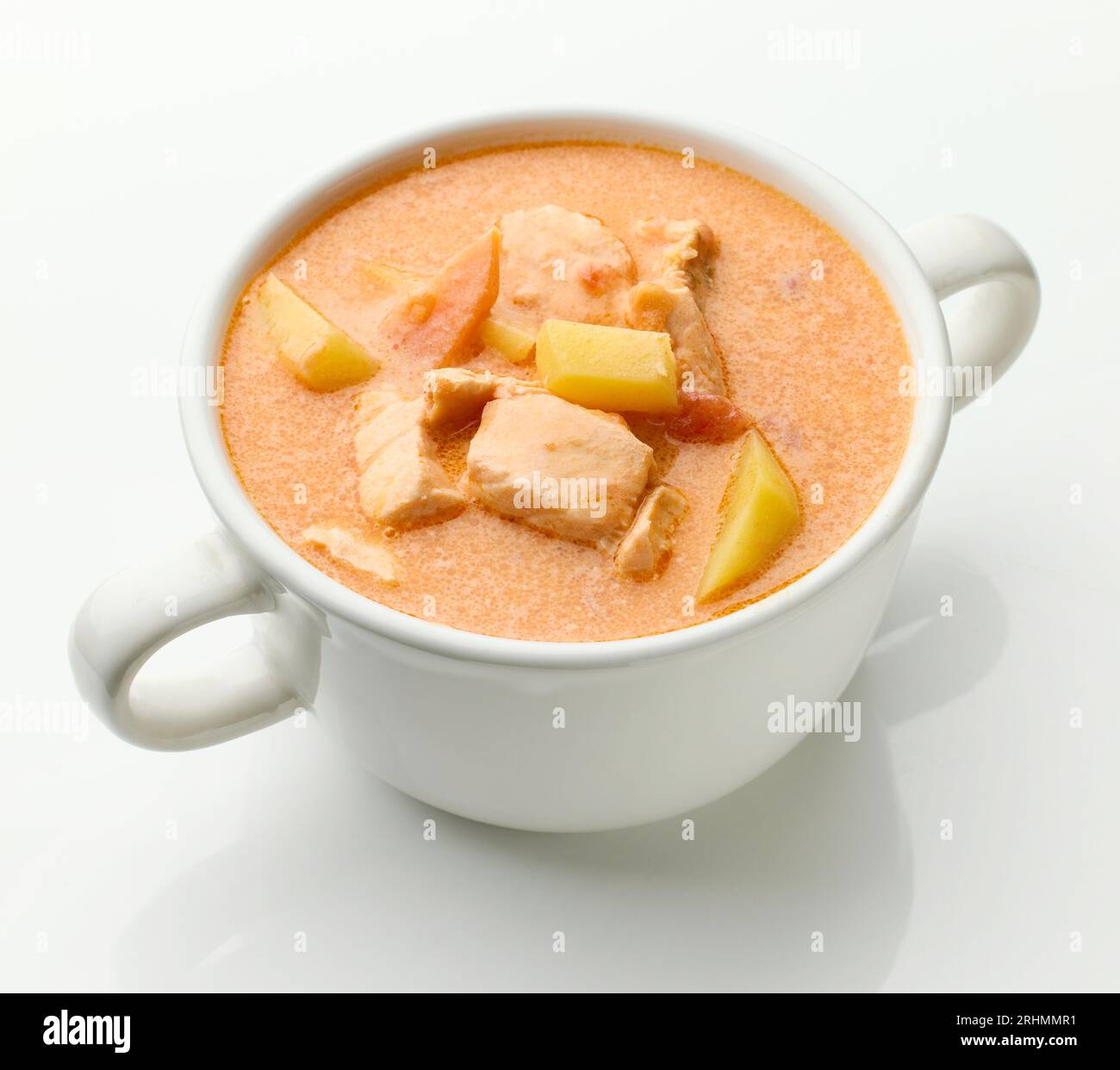ciotola di zuppa di salmone e pomodoro su sfondo bianco Foto Stock