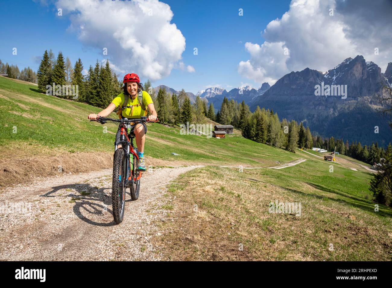 Italia, Veneto, provincia di Belluno, Selva di Cadore, Dolomiti, donne di 45 anni in e-bike / e-mtb su un sentiero di montagna Foto Stock