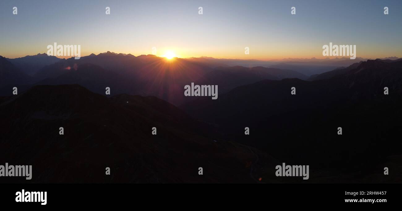 Sonnenaufgang hoch auf den Bergen - Sonnenaufgang am Gipfelkreuz Foto Stock