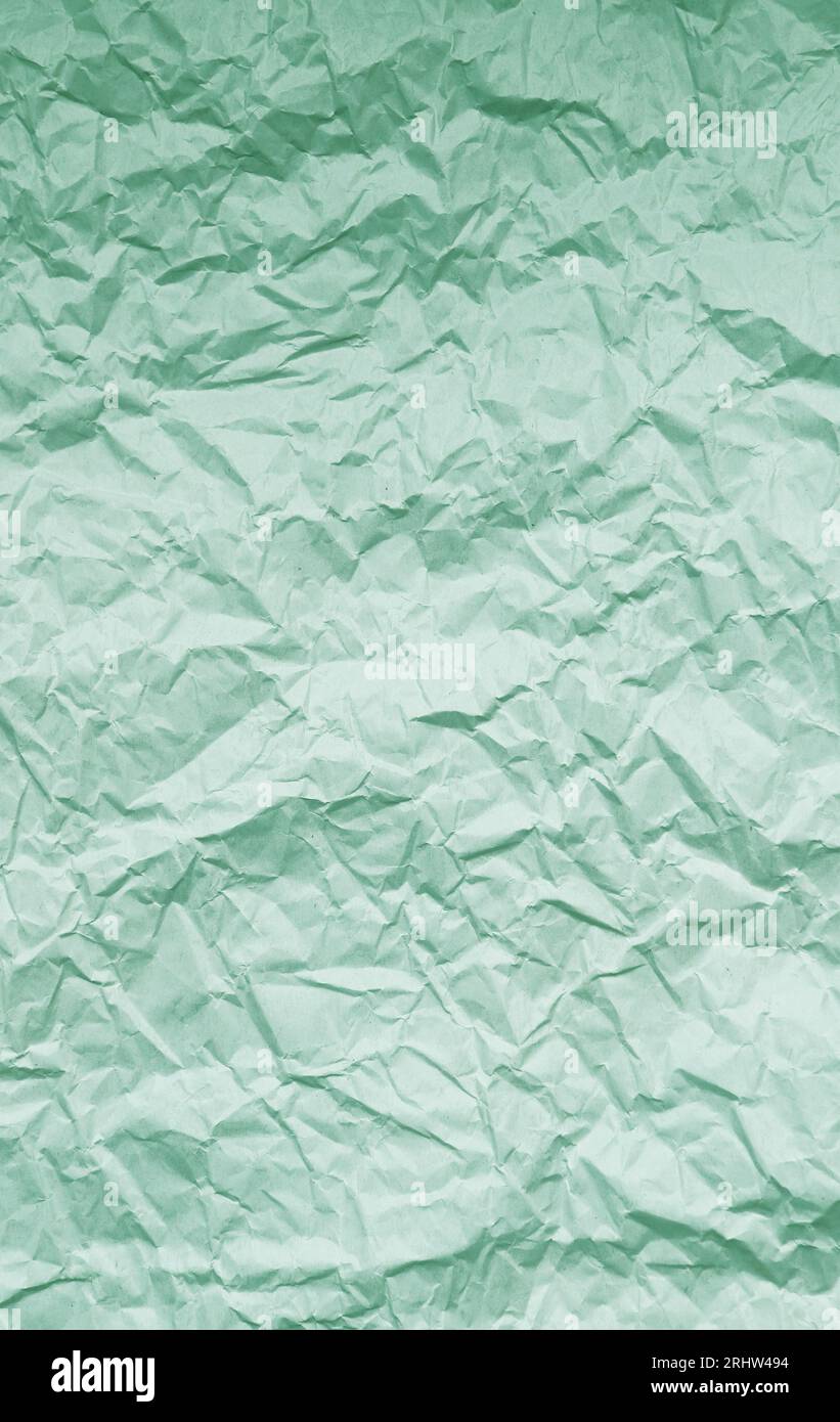 Texture di carta crumpled verde pistacchio pallido per sfondo astratto Foto Stock