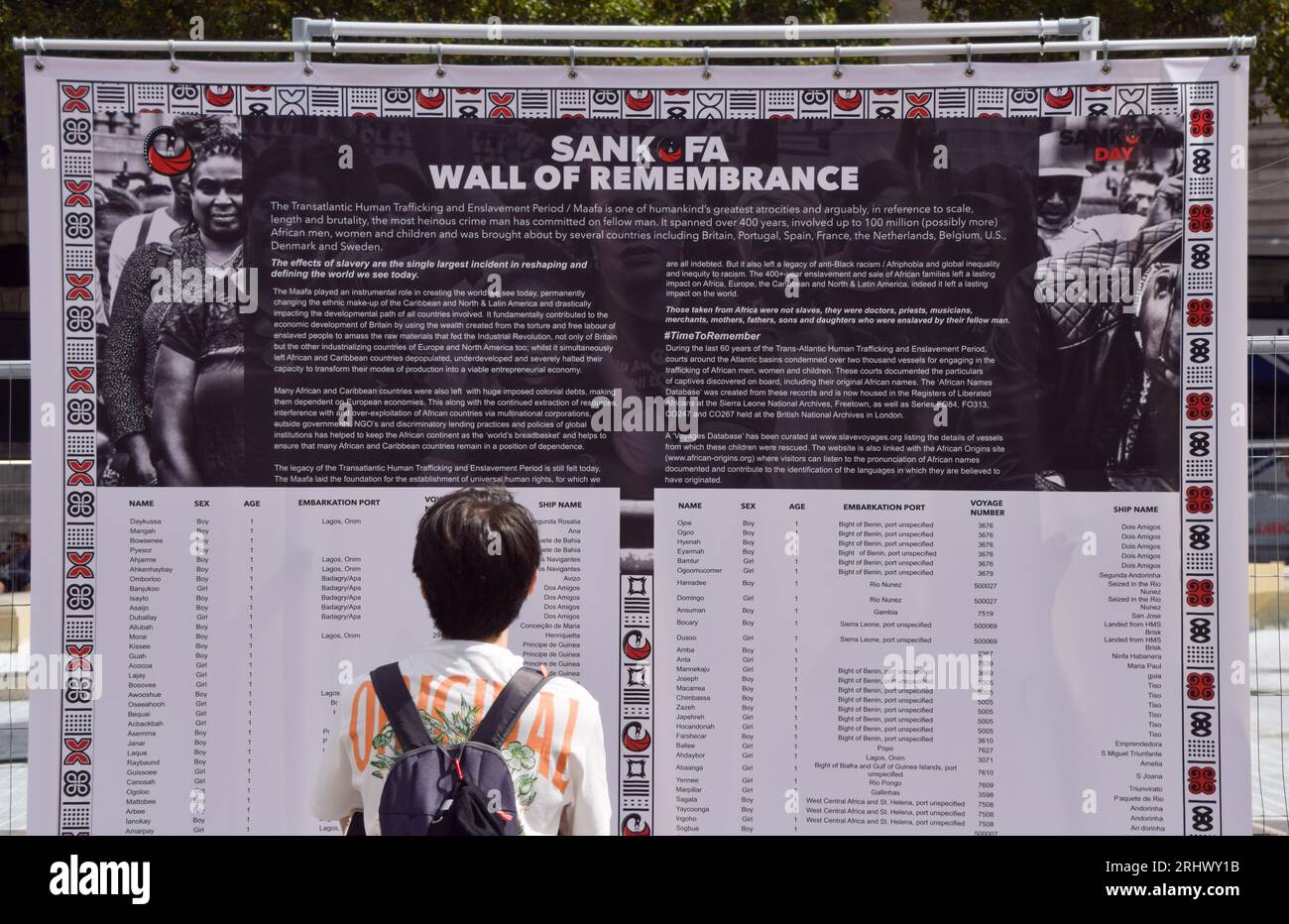 Londra, Inghilterra, Regno Unito. 19 agosto 2023. Un passante legge i nomi degli schiavi sul muro della memoria. Gli attivisti della memoria della schiavitù si sono riuniti a Trafalgar Square per commemorare il Sankofa Day, una celebrazione della grande Rivoluzione haitiana e per celebrare la giornata internazionale per la memoria del commercio degli schiavi e la sua abolizione. (Immagine di credito: © Vuk Valcic/ZUMA Press Wire) SOLO USO EDITORIALE! Non per USO commerciale! Foto Stock