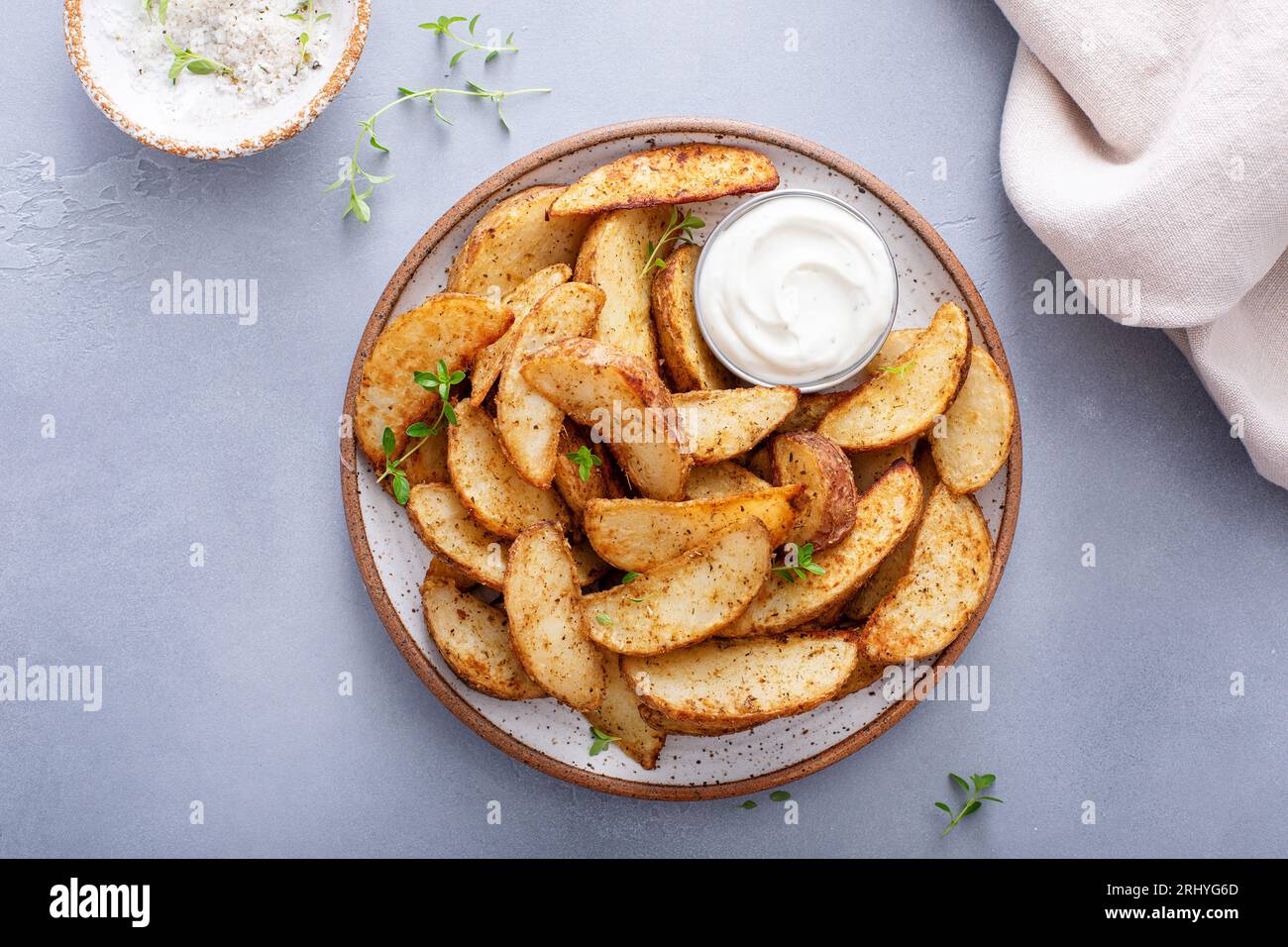 Spicchi di patate al forno con erbe e parmigiano serviti con salsa Foto Stock