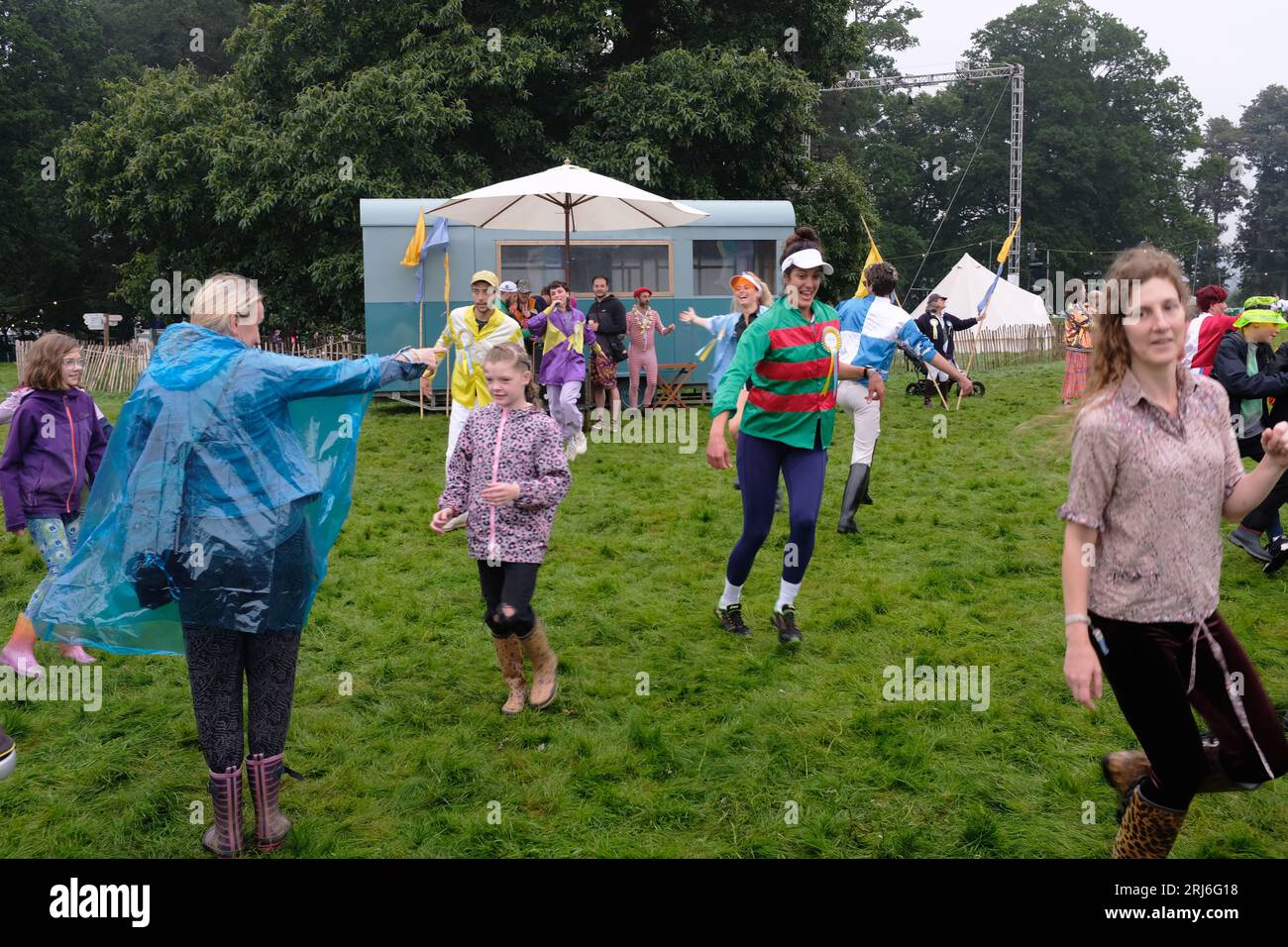 Persone che ballano sotto la pioggia in un festival nel Regno Unito Foto Stock