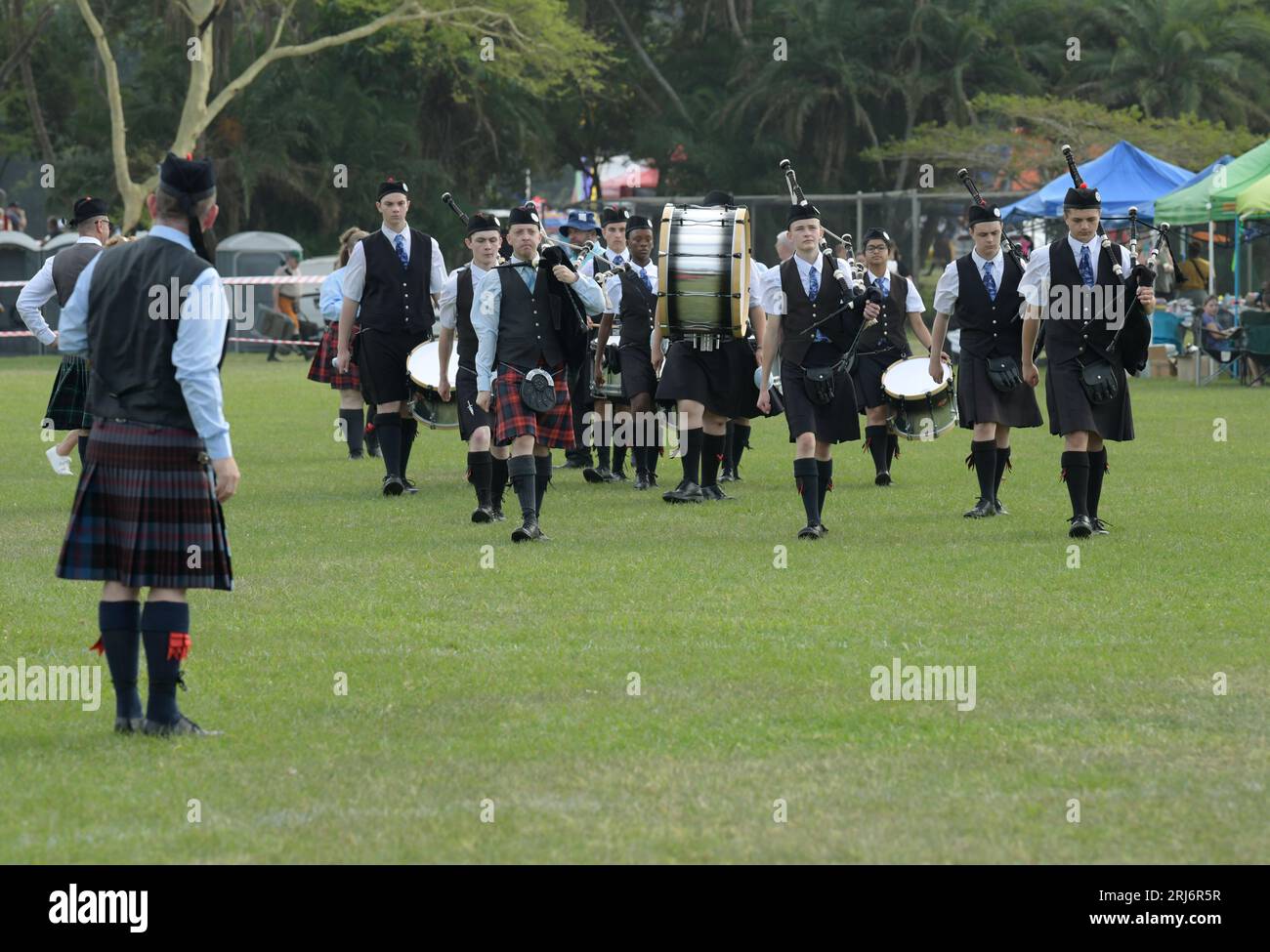 Group of People Marching, Benoni Pipes and drums band scozzese, 60th Annual, Highland Gathering 2023, Amanzimtoti, Sud Africa, concorso musicale Foto Stock