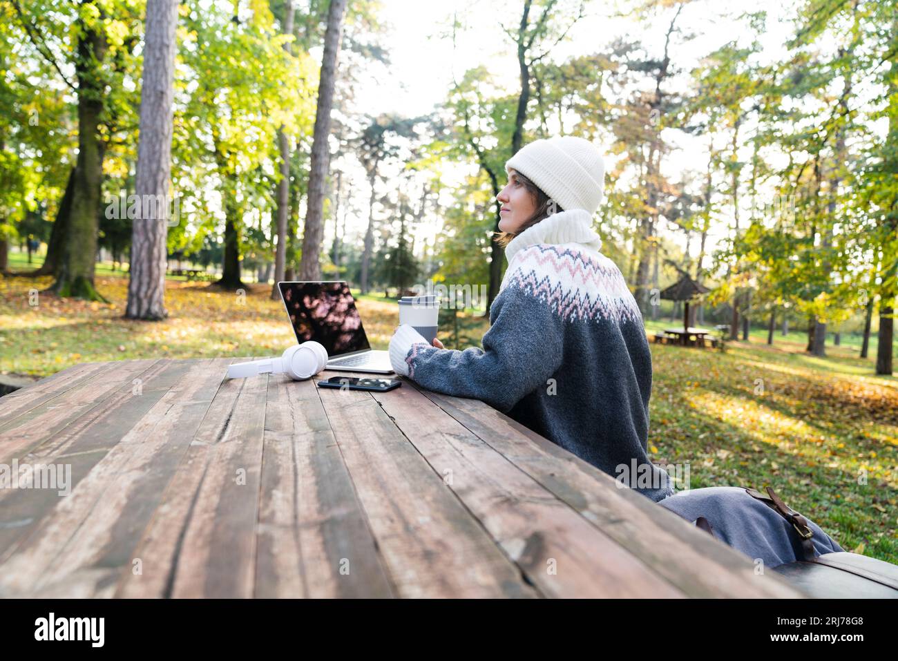 Freelance che lavora su un notebook nel parco autunnale. Foto Stock